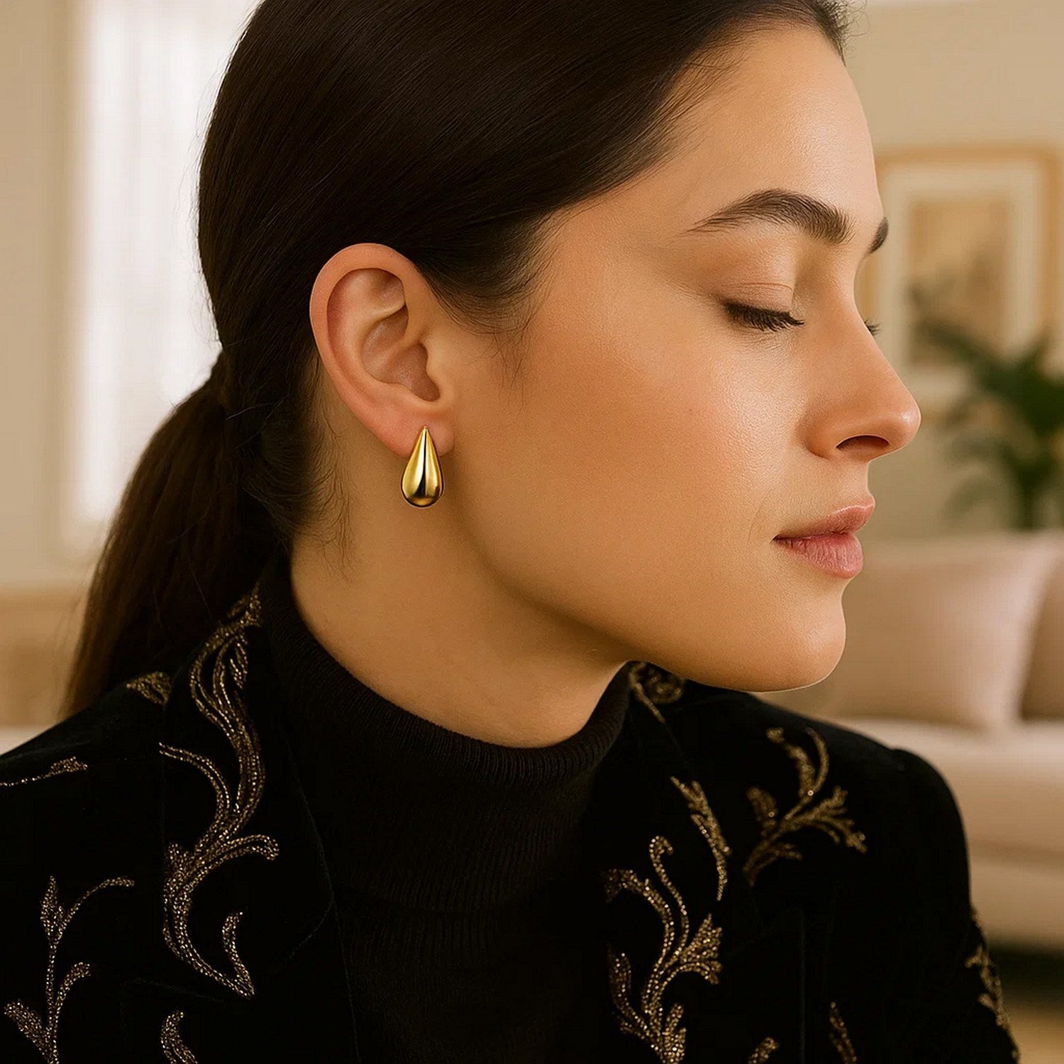 Elegant 14k yellow gold textured raindrop earrings featuring a chic drop design for a luxurious touch.
