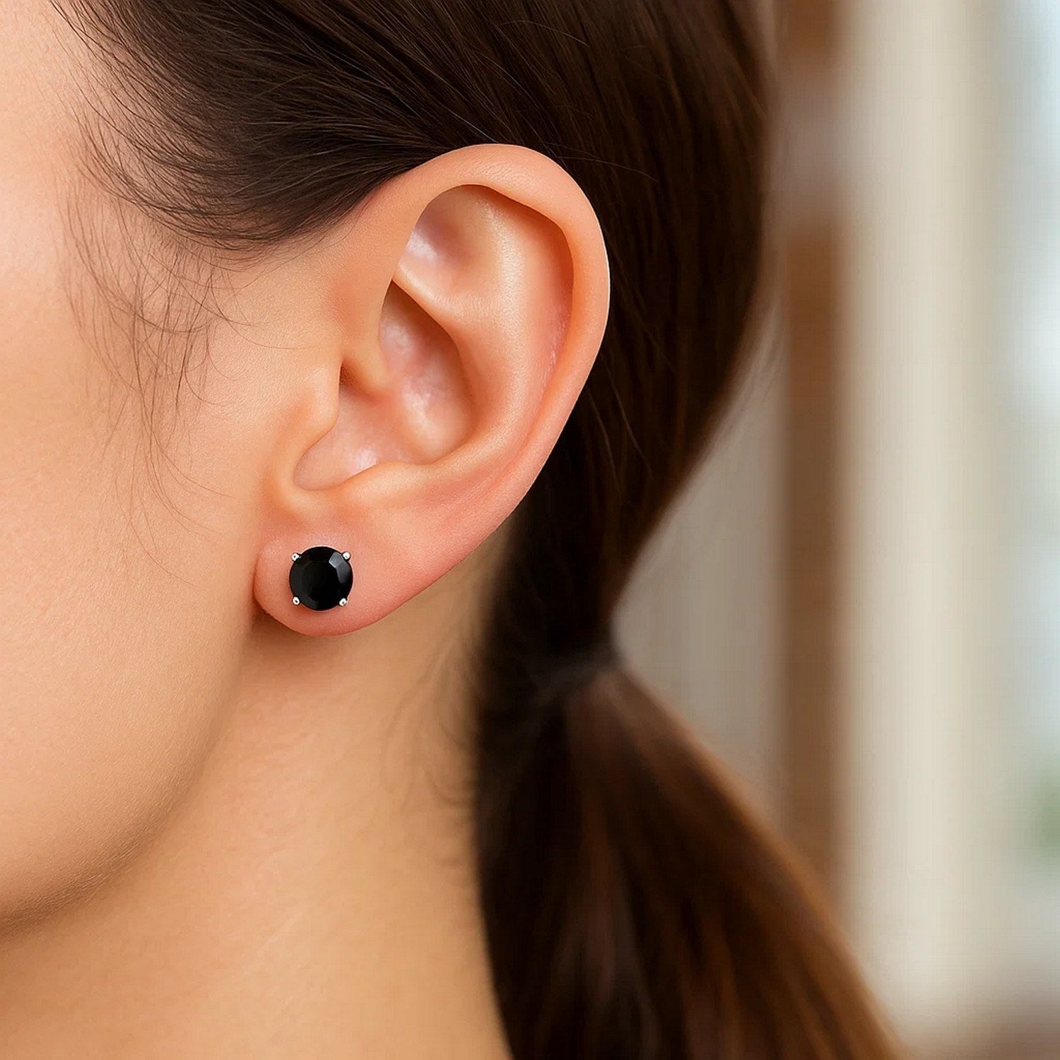 14k white gold stud earrings featuring faceted black cubic zirconia for a classic, elegant look.