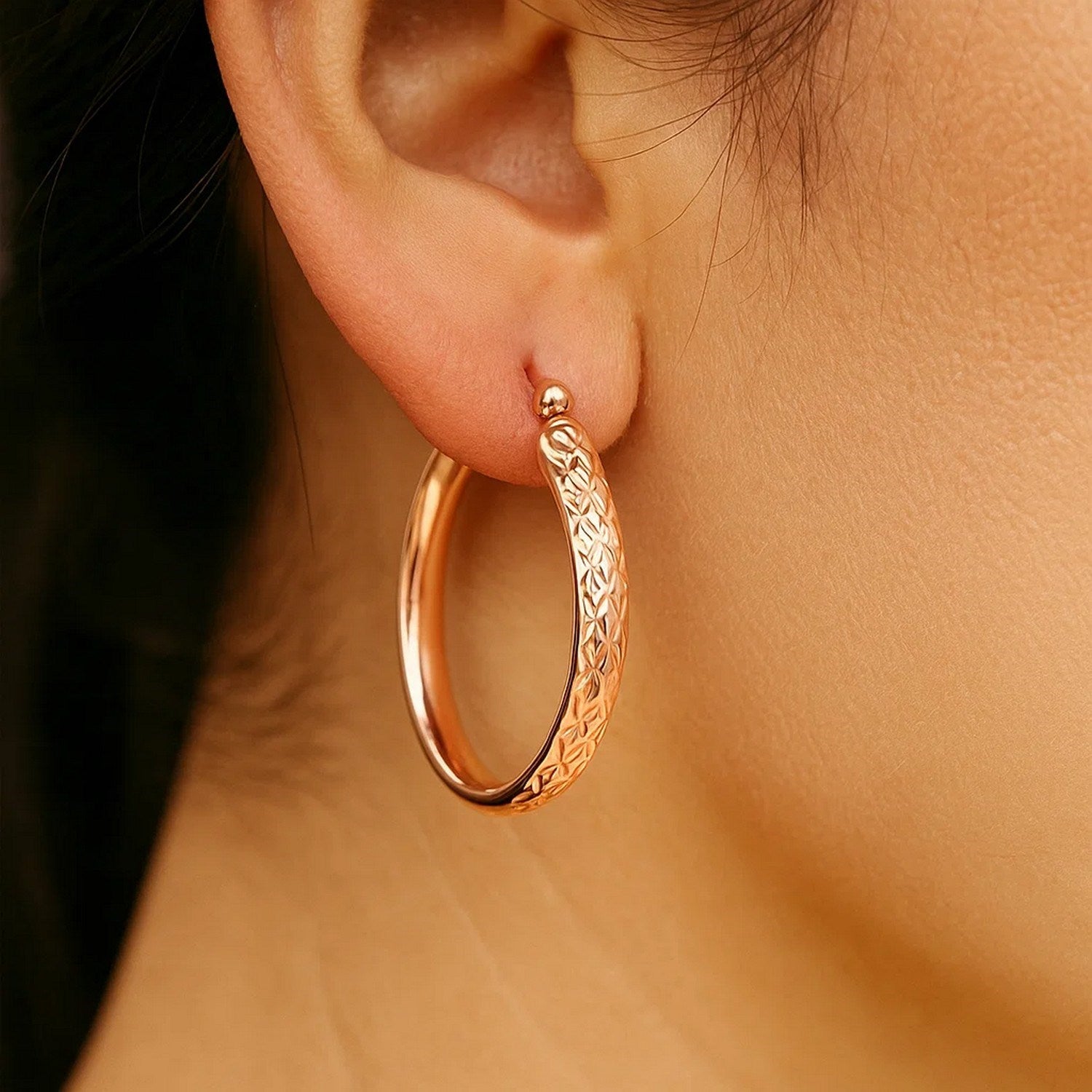 14k rose gold hammered oval hoop earrings with a contemporary design, perfect for elegant everyday wear.