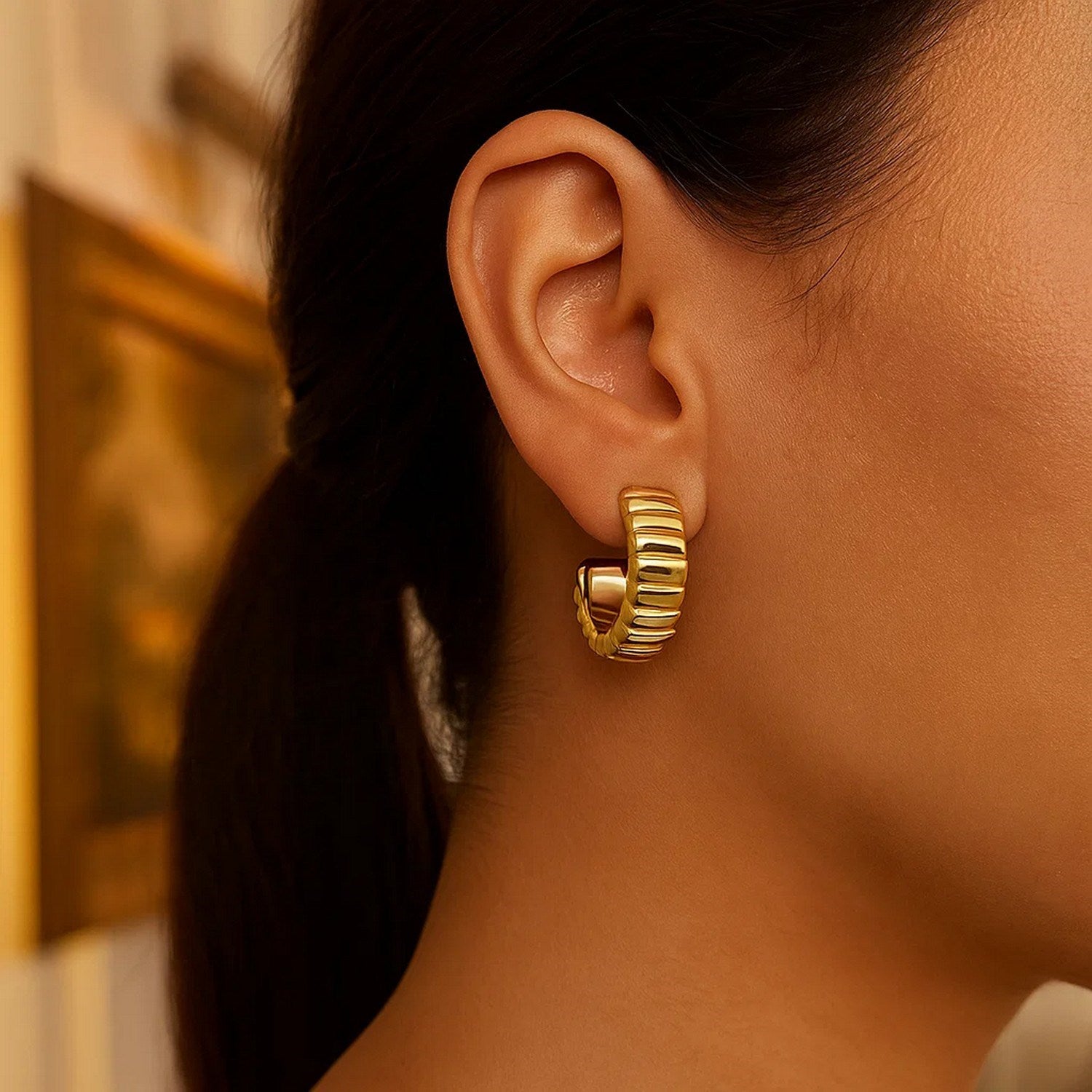 14k yellow gold ribbed C hoop earrings featuring a modern design, perfect for elegant everyday wear.