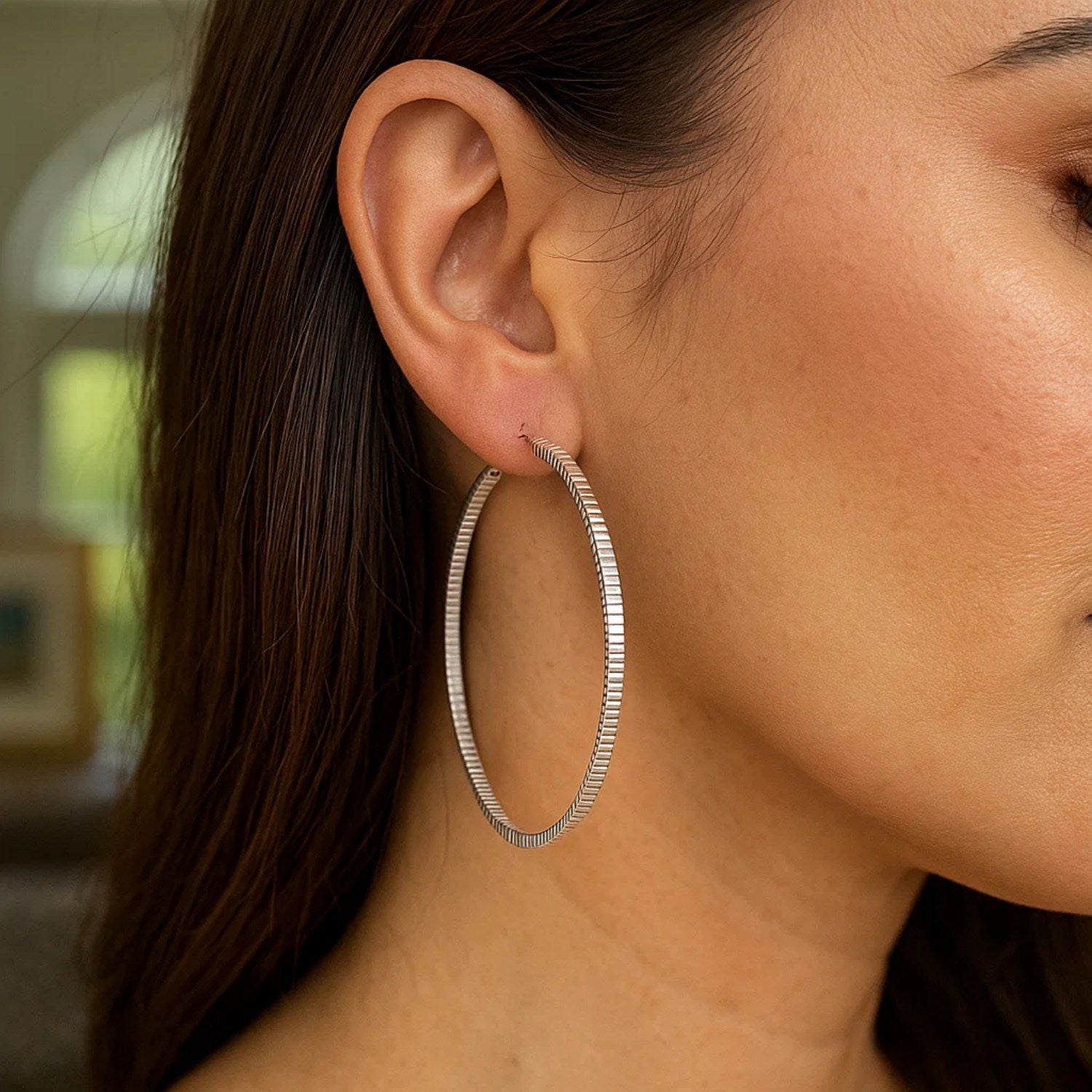 Sterling silver textured hoop earrings showcasing modern design and exquisite craftsmanship from Giorgi Elkani.