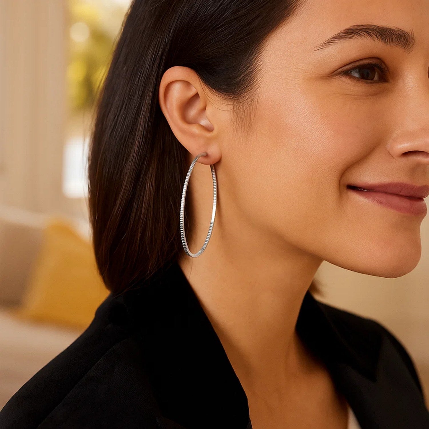 Sterling silver textured hoop earrings showcasing modern elegance and refined craftsmanship.