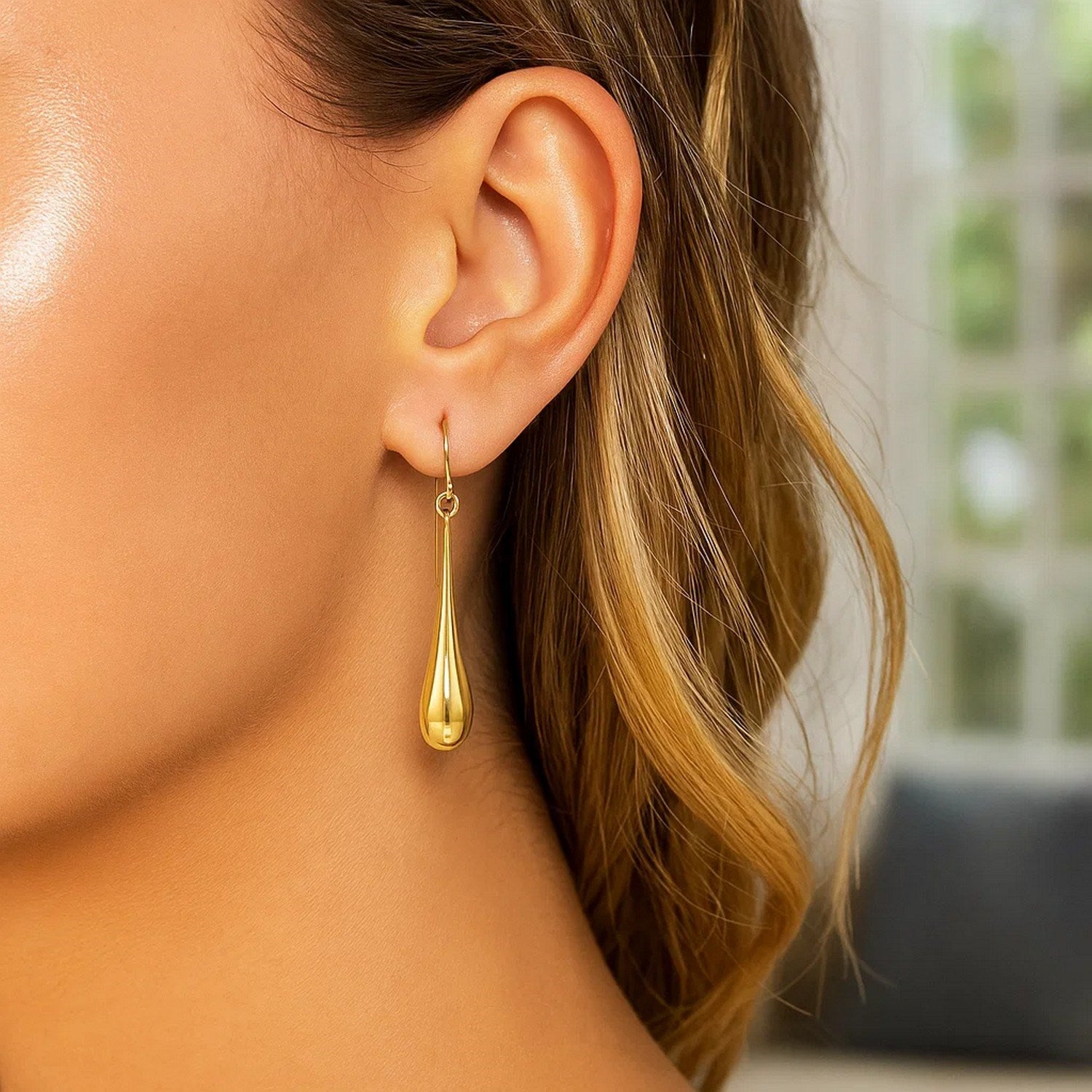 14k yellow gold polished teardrop dangle earrings exuding elegance and sophistication for any occasion.