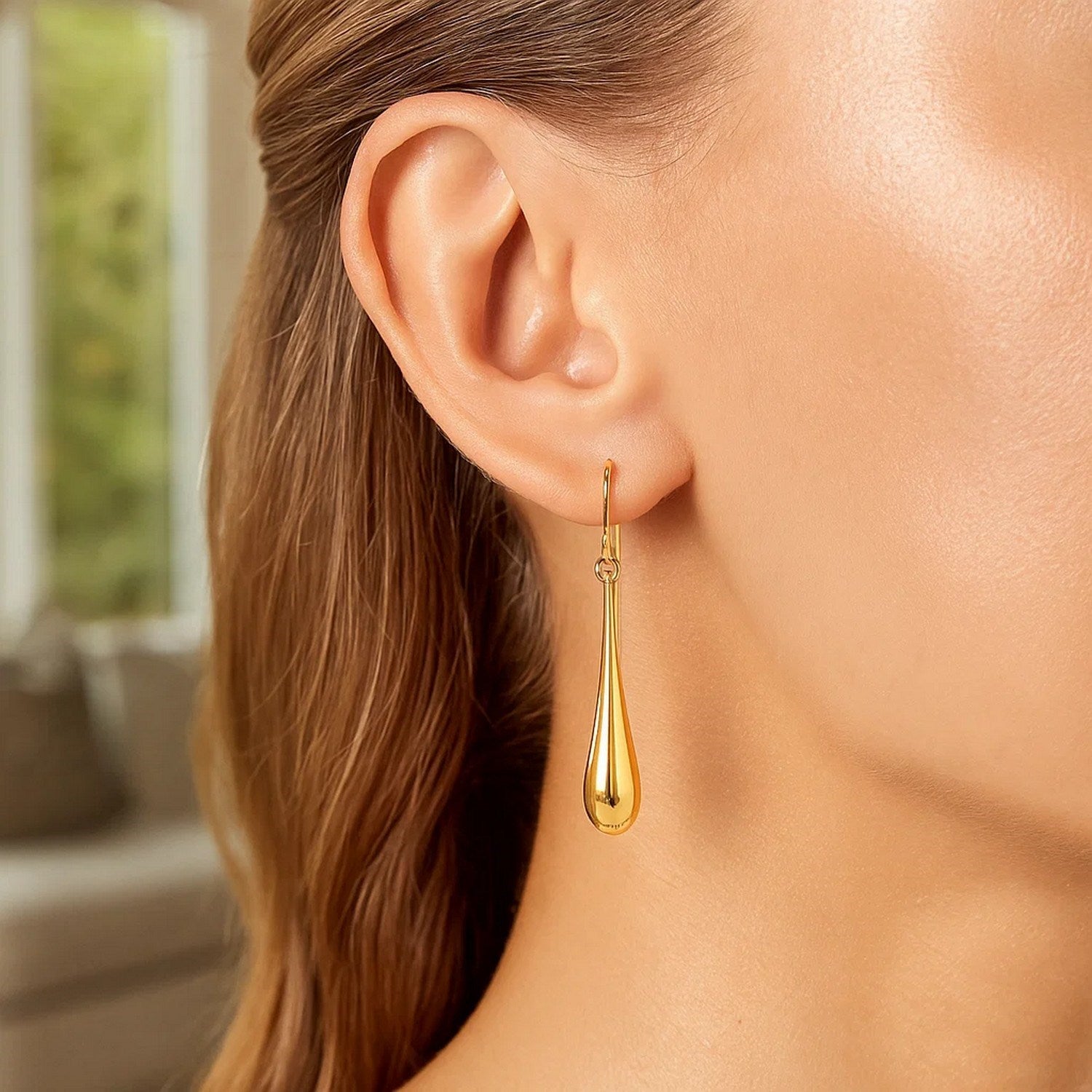Elegant 14k yellow gold polished teardrop dangle earrings, showcasing a refined drop design for timeless luxury.