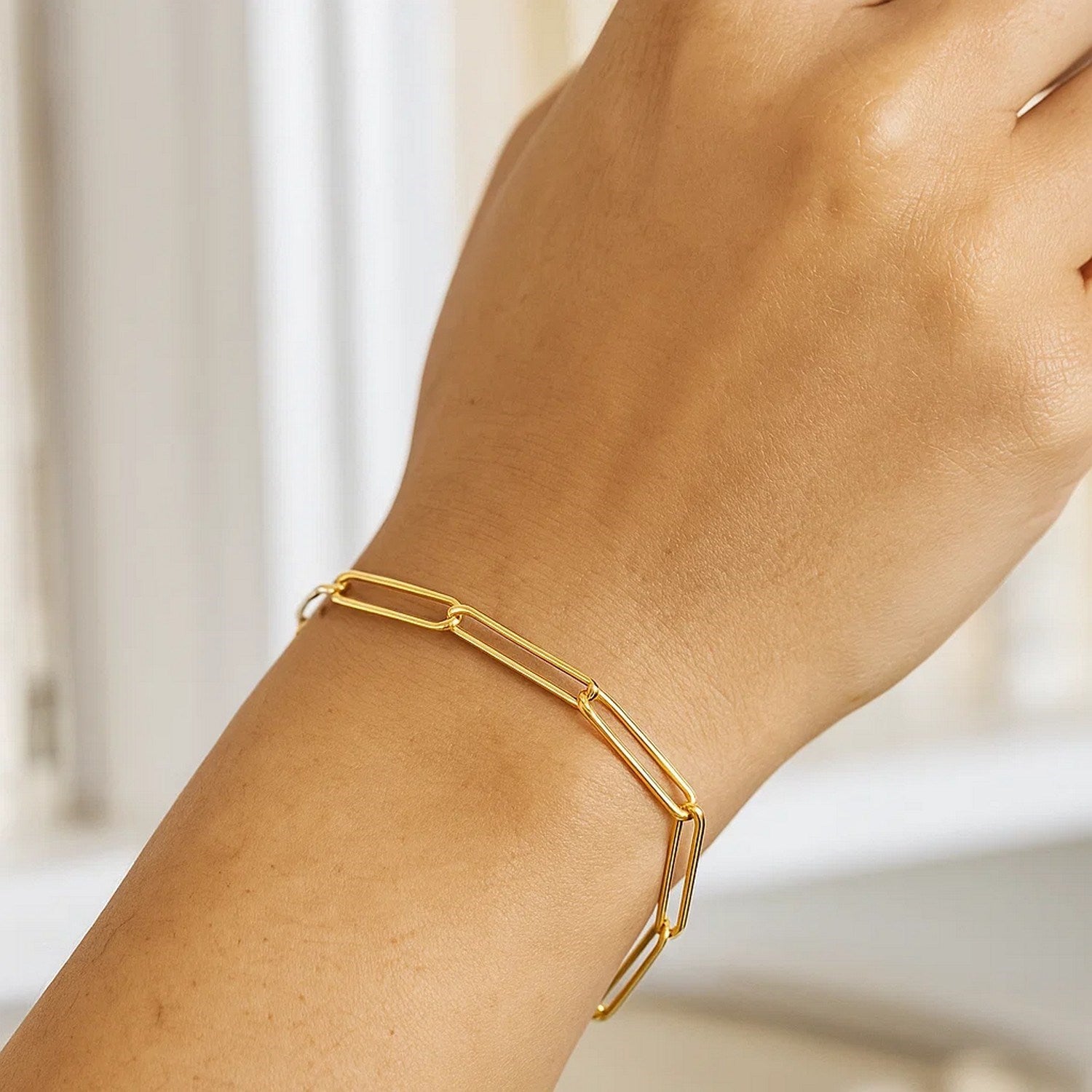 14k yellow gold wire paperclip bracelet featuring contemporary round links, perfect for elegant layering or solo wear.