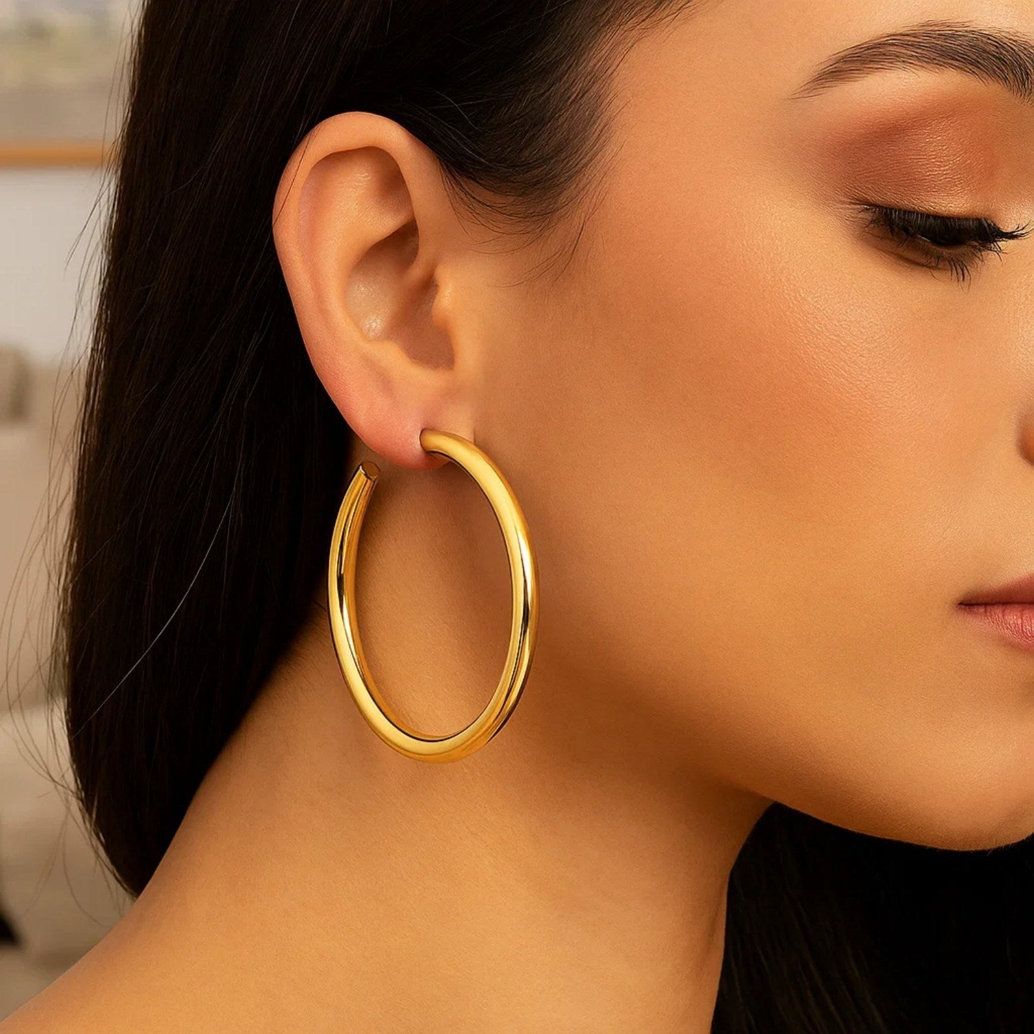 14k yellow gold polished hoop earrings showcasing a sleek, modern design for elegant everyday wear.