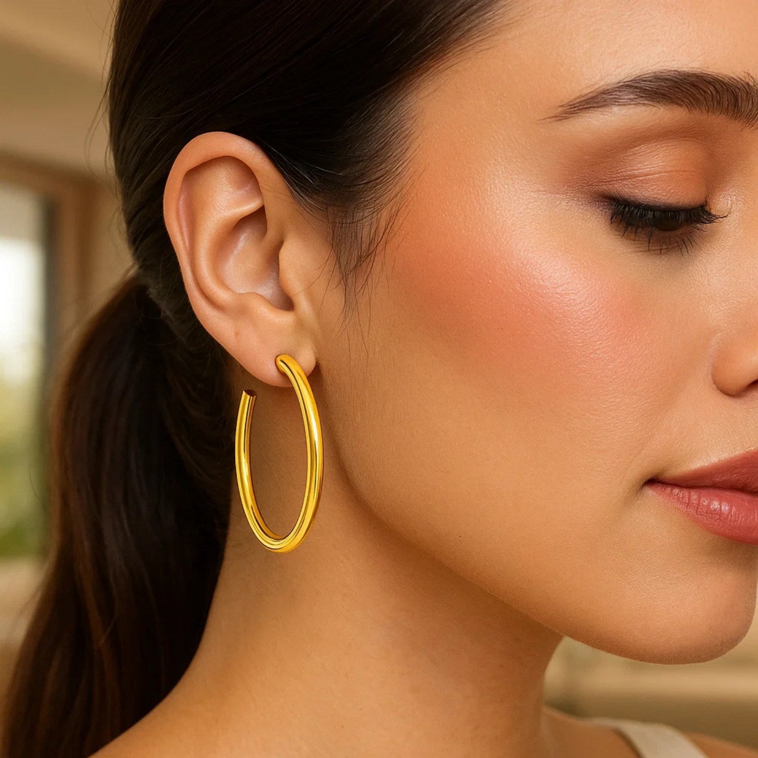 14k yellow gold polished hoop earrings showcasing a sleek modern design, perfect for elegant everyday wear.