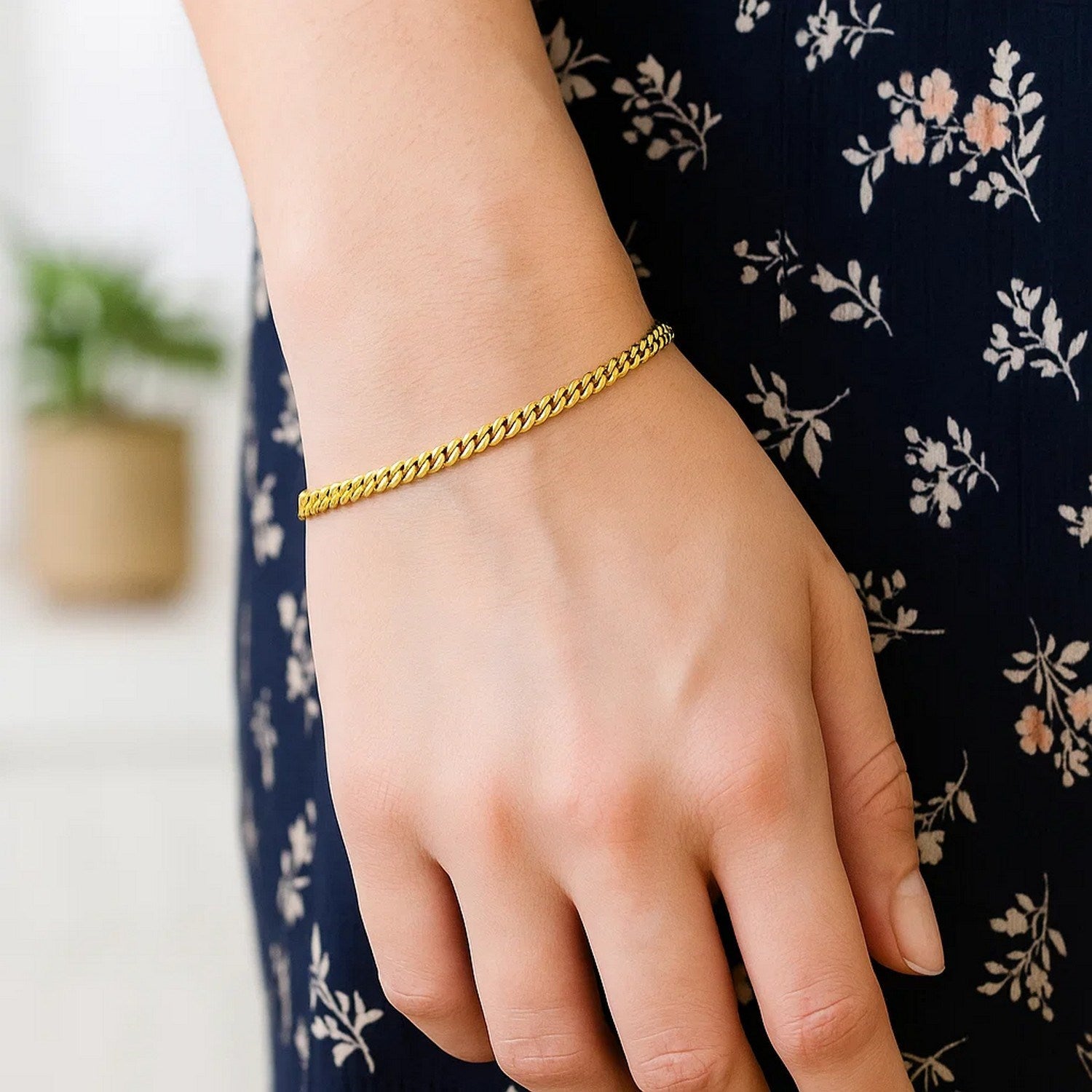 14k yellow gold petite faceted Cuban link chain bracelet, elegantly designed with 4.50 mm links for a luxurious touch.
