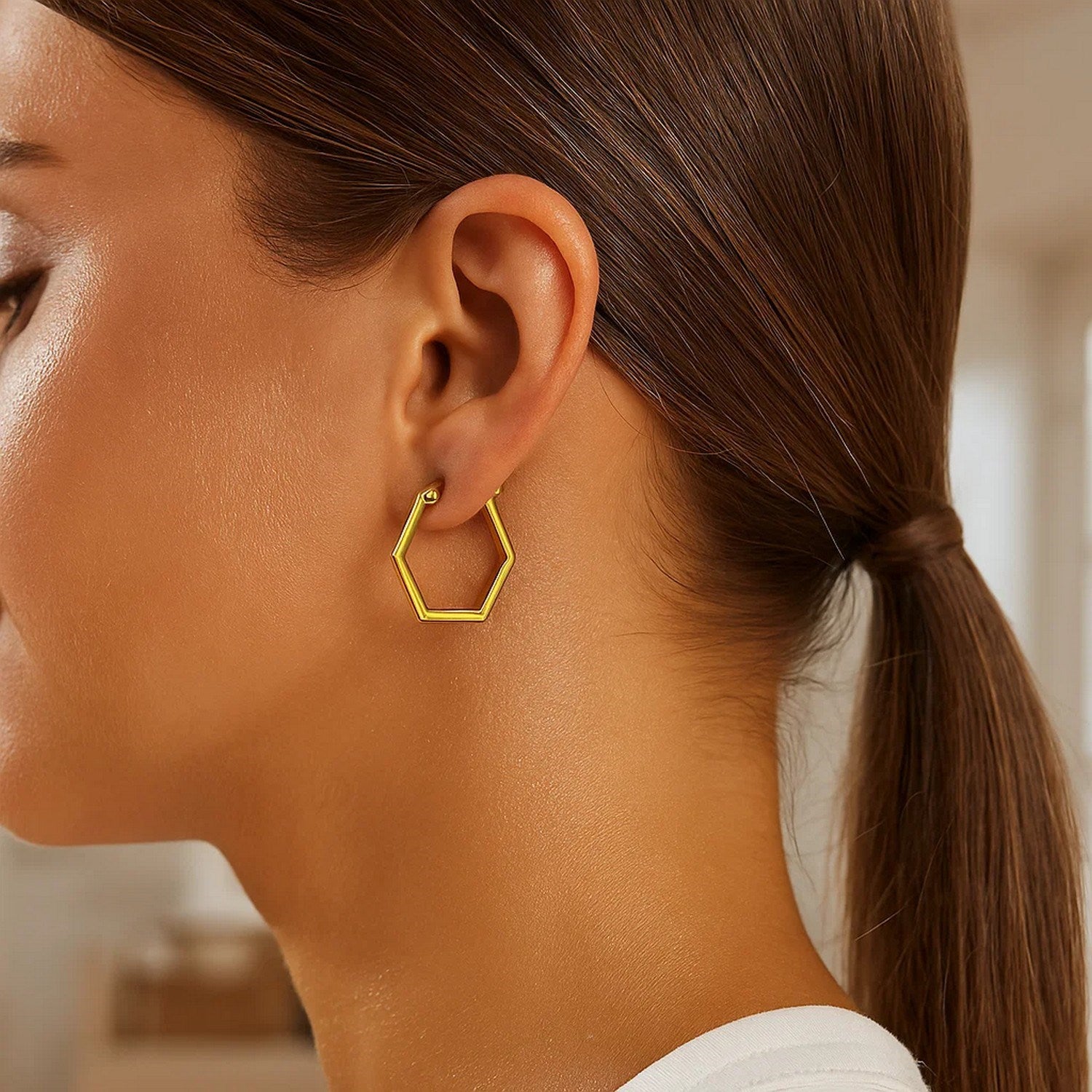 14K yellow gold polished hoop earrings with a sleek modern design, perfect for elegant everyday wear.