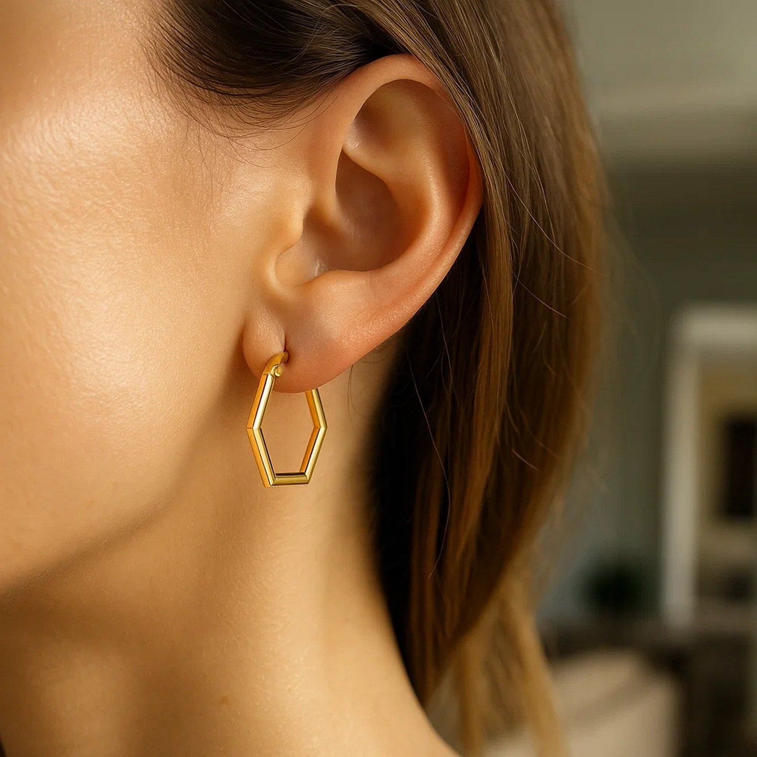 14k yellow gold polished hoop earrings showcasing a modern design with a sleek, lustrous finish.