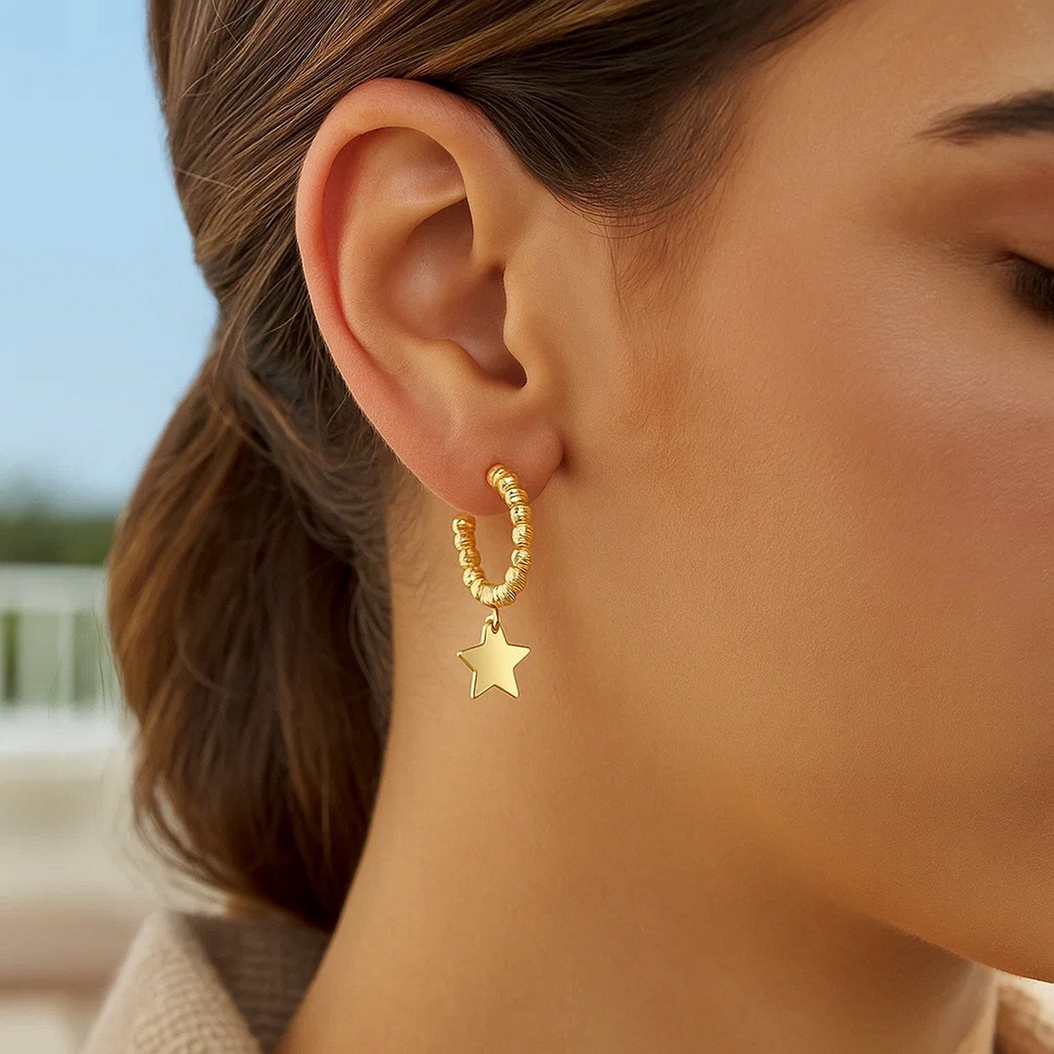14K yellow gold beaded hoop drop earrings showcasing elegant design and luxurious craftsmanship.
