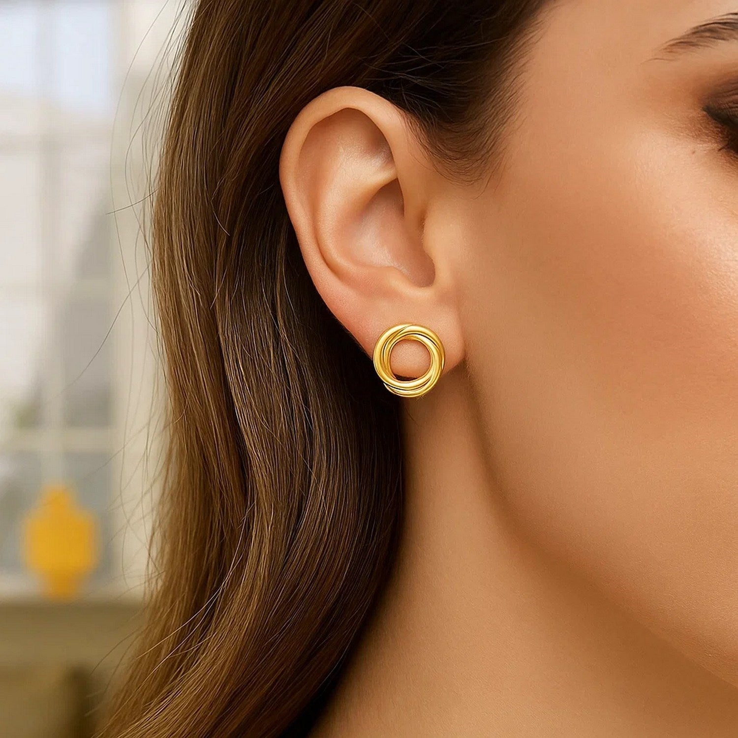 14K yellow gold polished interlocking trinity stud earrings with a modern design, perfect for elegant occasions.