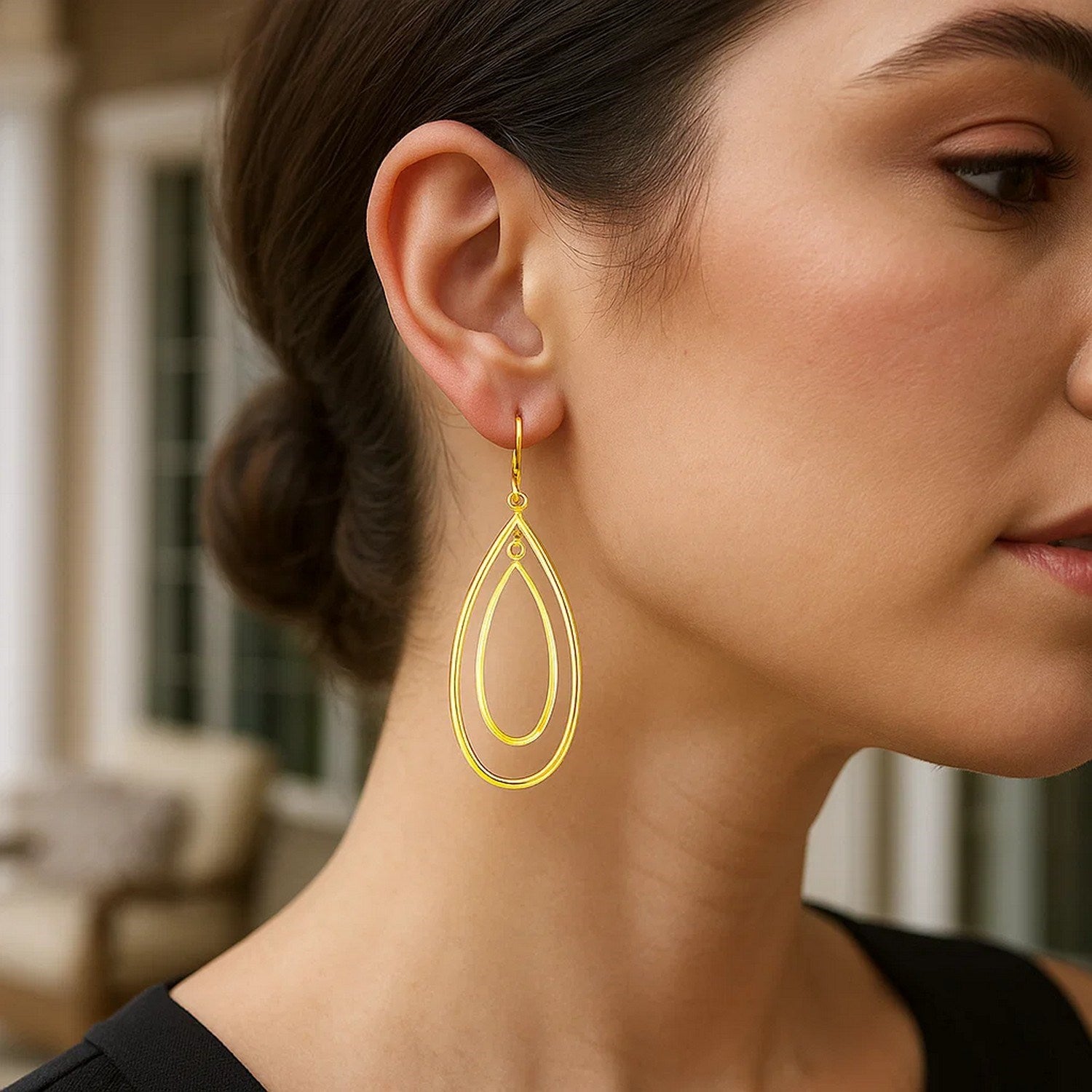 Elegant 14k yellow gold teardrop dangle earrings showcasing a refined design and luxurious shine.