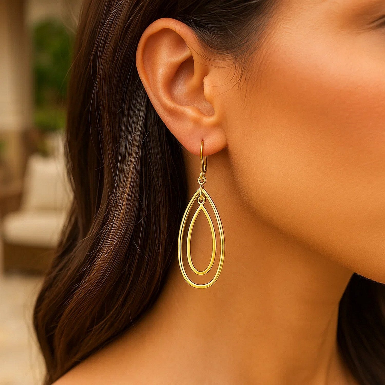 Elegant 14k yellow gold teardrop dangle earrings showcasing a refined drop design for timeless luxury.