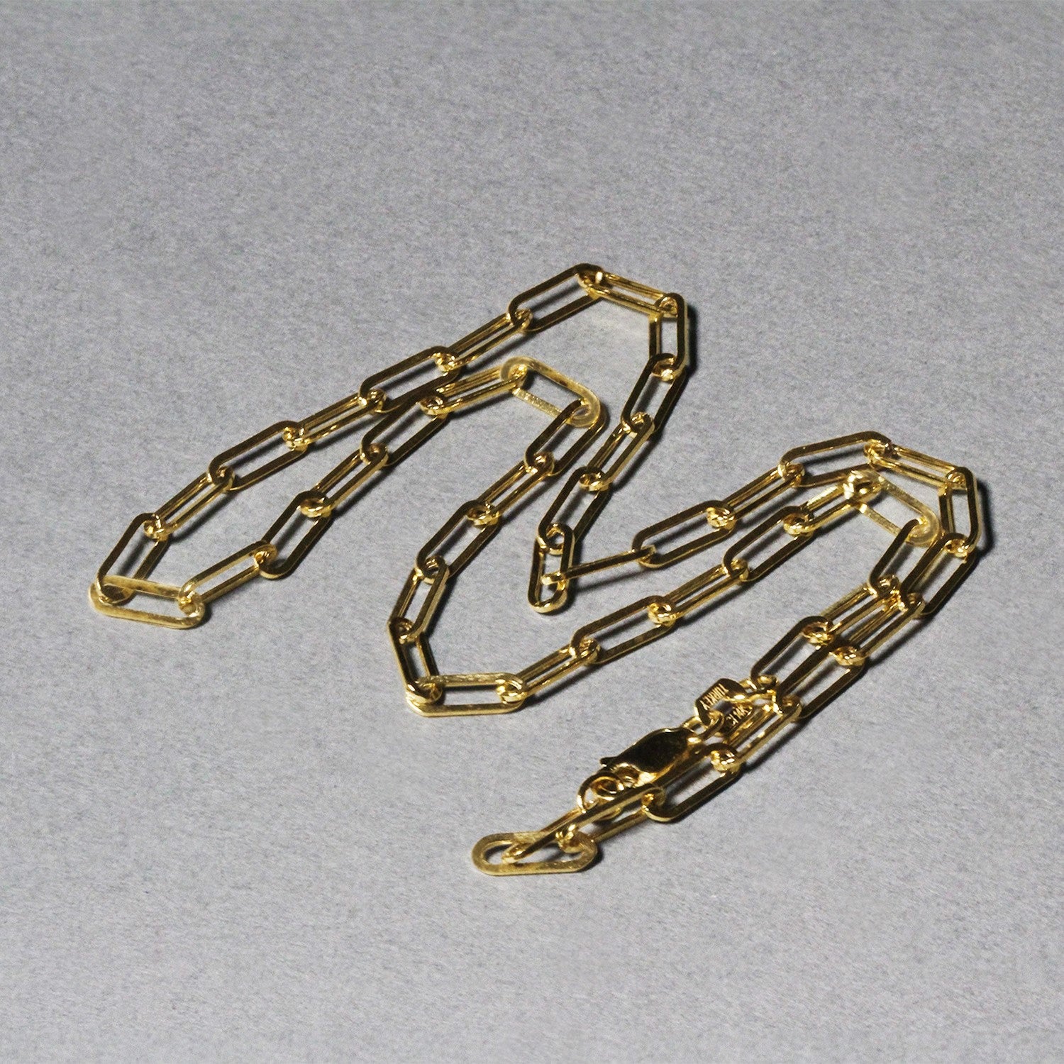 14K yellow gold wide paperclip chain featuring modern links, perfect for layering or as a statement piece.