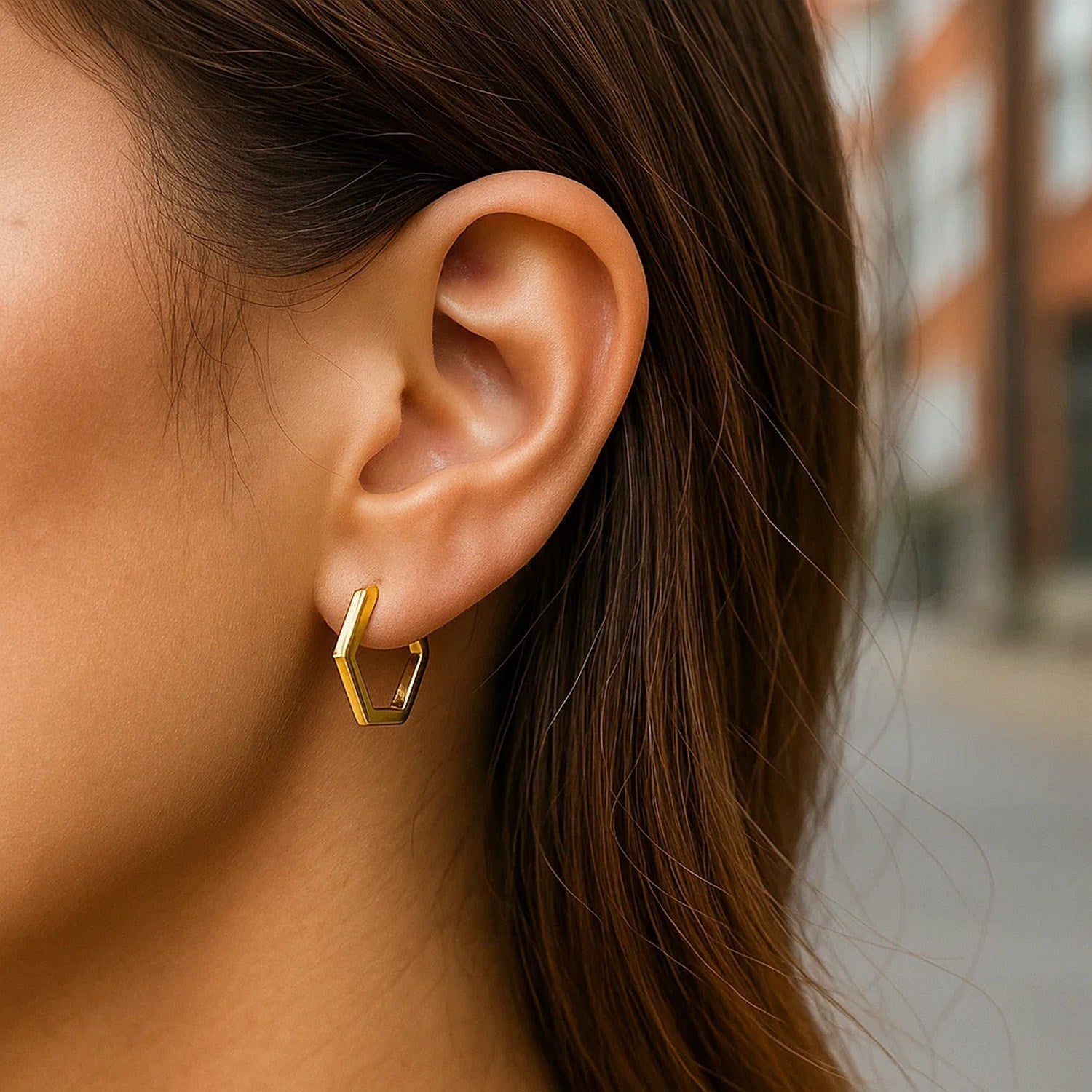 14k yellow gold polished hoop huggie earrings with a sleek modern design, perfect for elegant everyday wear.