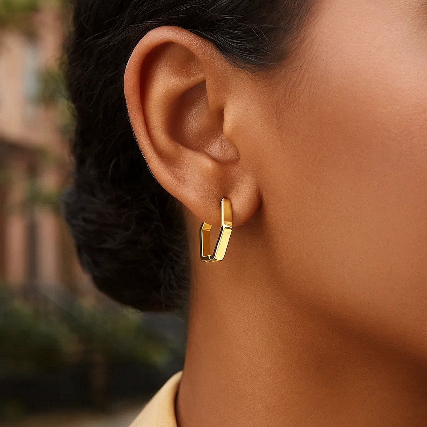 14k yellow gold polished hoop huggie earrings with a sleek modern design, perfect for elegant everyday wear.