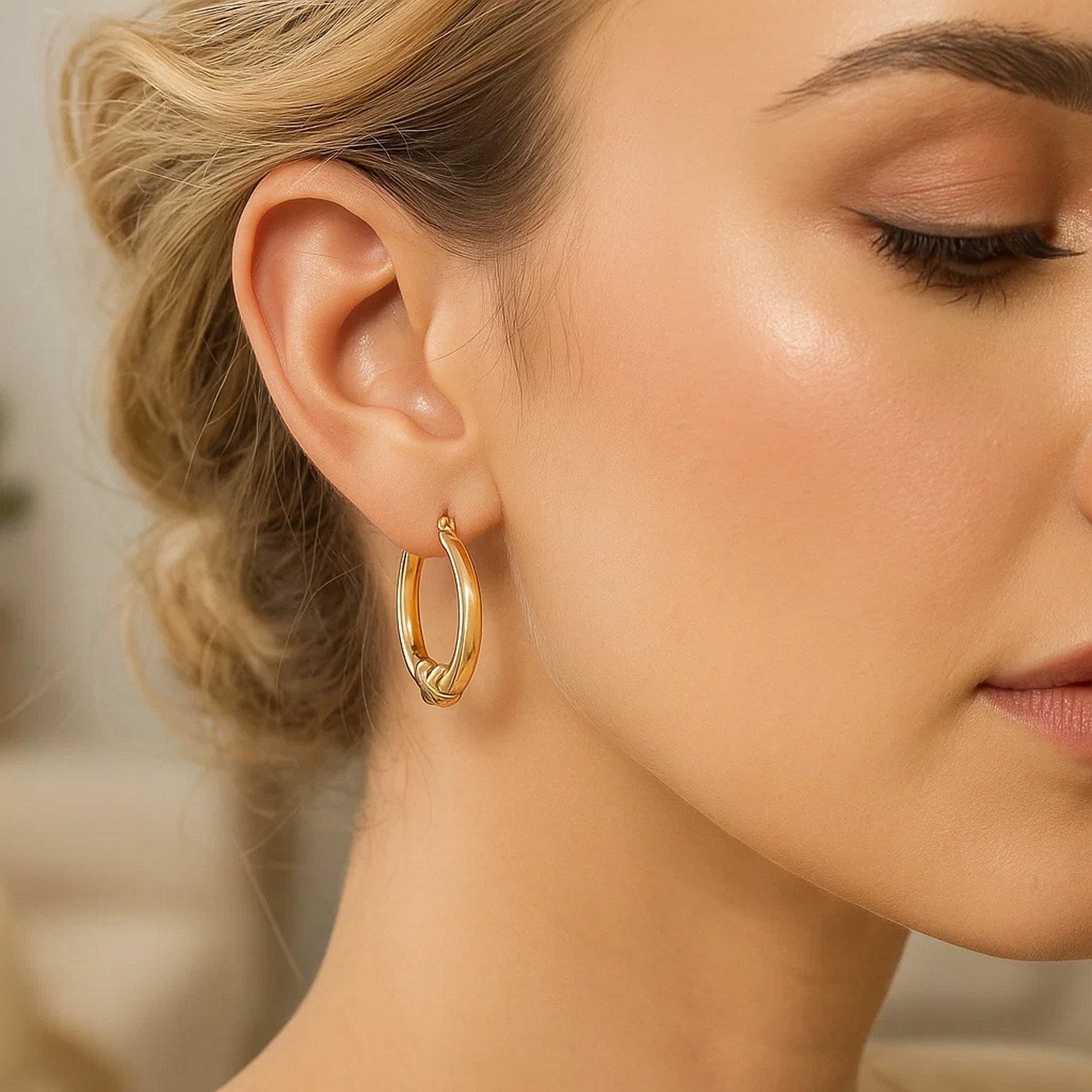 14k yellow gold modern round hoop earrings featuring a chic X motif for a luxurious statement look.