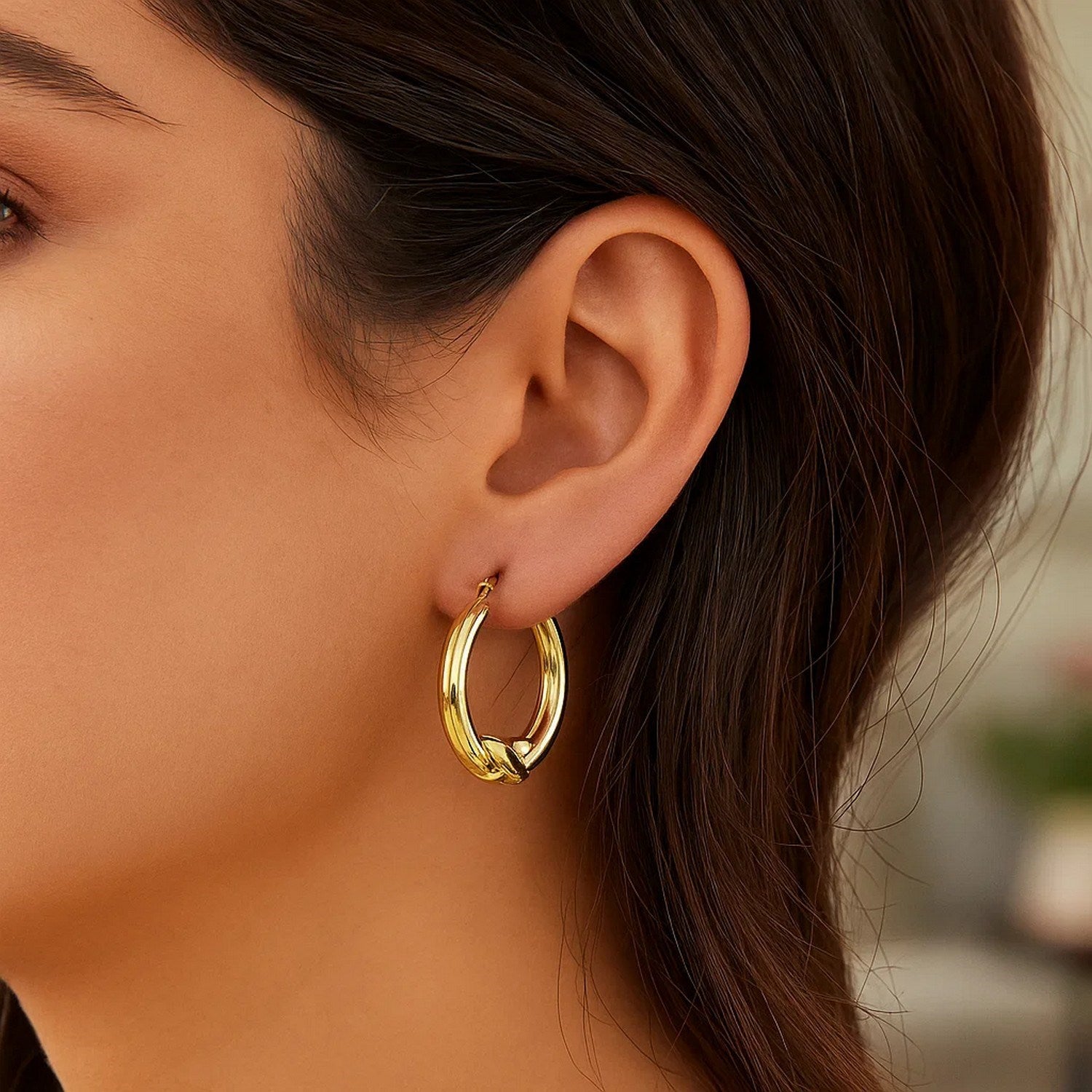 14k yellow gold modern round hoop earrings featuring a sleek X motif for a chic, elegant look.