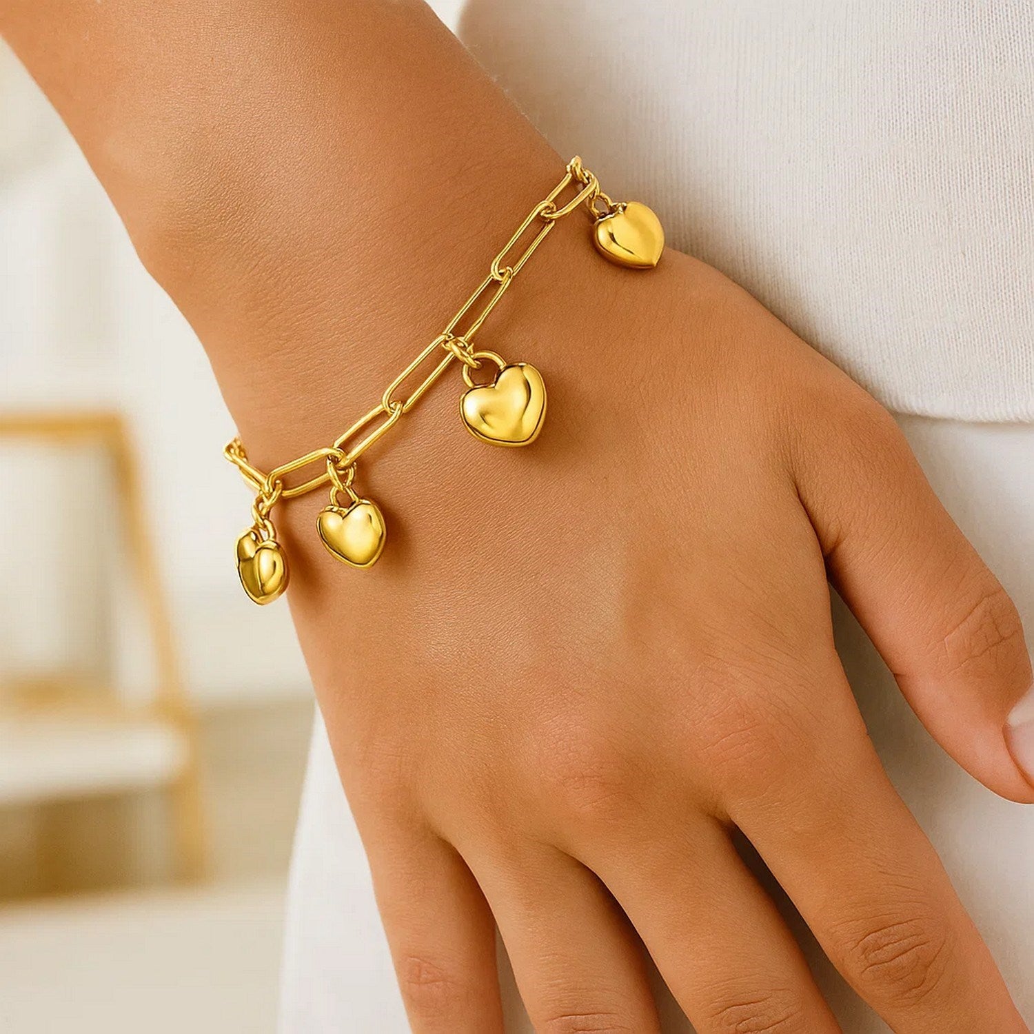 Elegant 14k yellow gold puffed heart charm bracelet with a delicate chain design, perfect for luxurious everyday wear.