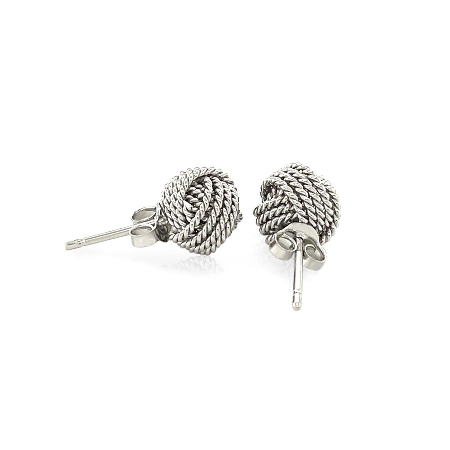 Sterling silver textured love knot stud earrings, elegantly designed for timeless sophistication and everyday wear.