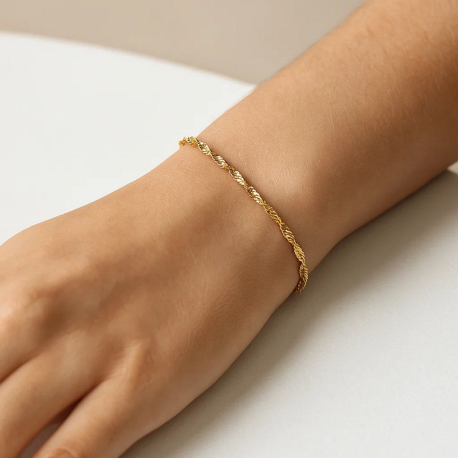 Elegant 10k yellow gold Singapore bracelet featuring a delicate chain design, perfect for sophisticated styling.
