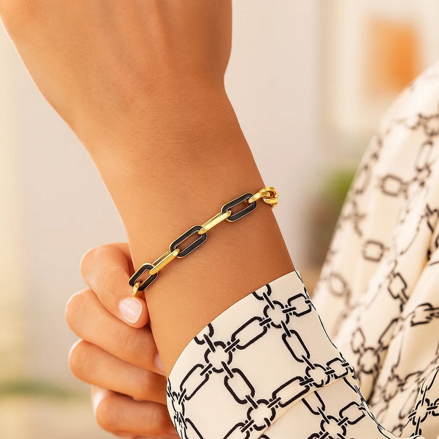 14k yellow gold modern paperclip bracelet featuring striking black onyx links, perfect for elegant layering.