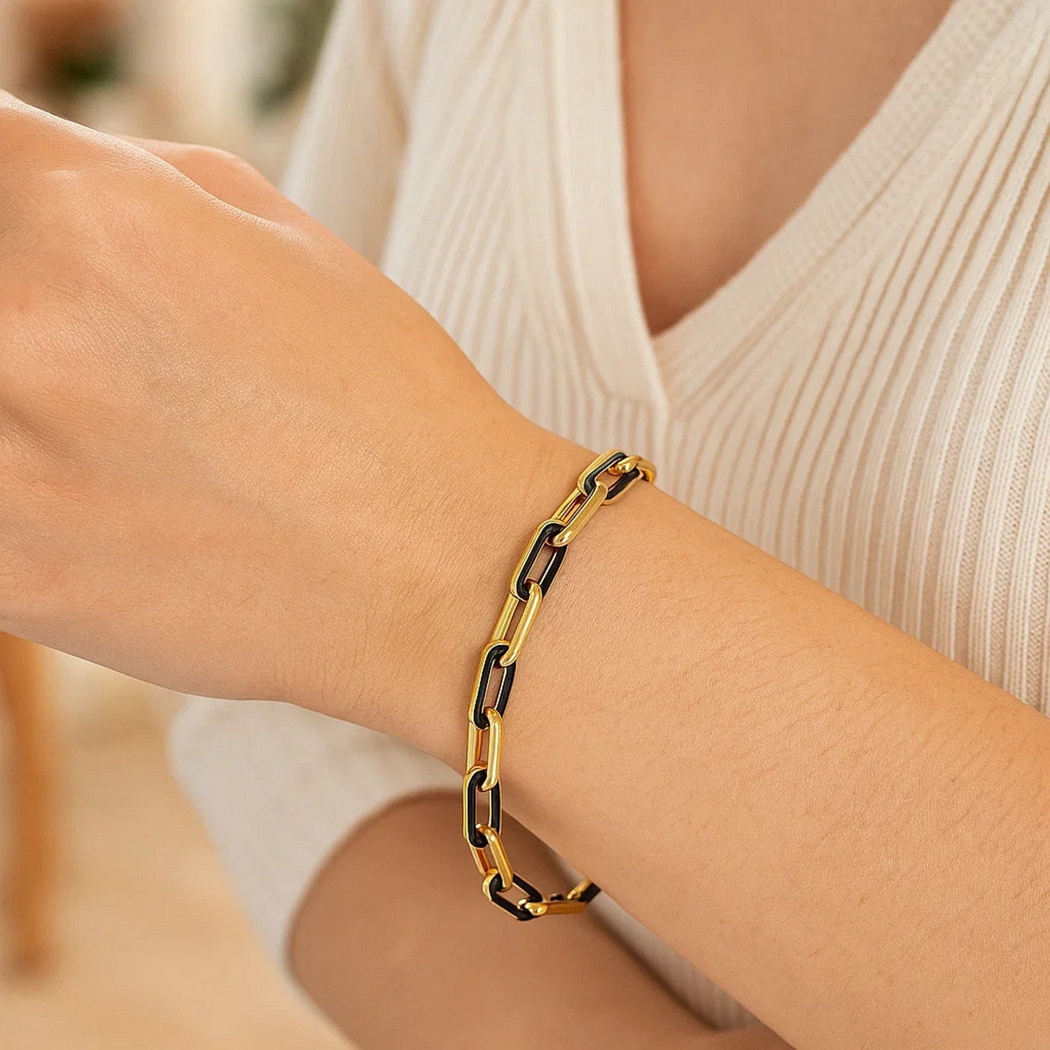 14k yellow gold modern paperclip bracelet featuring striking black onyx links, perfect for elegant layering.