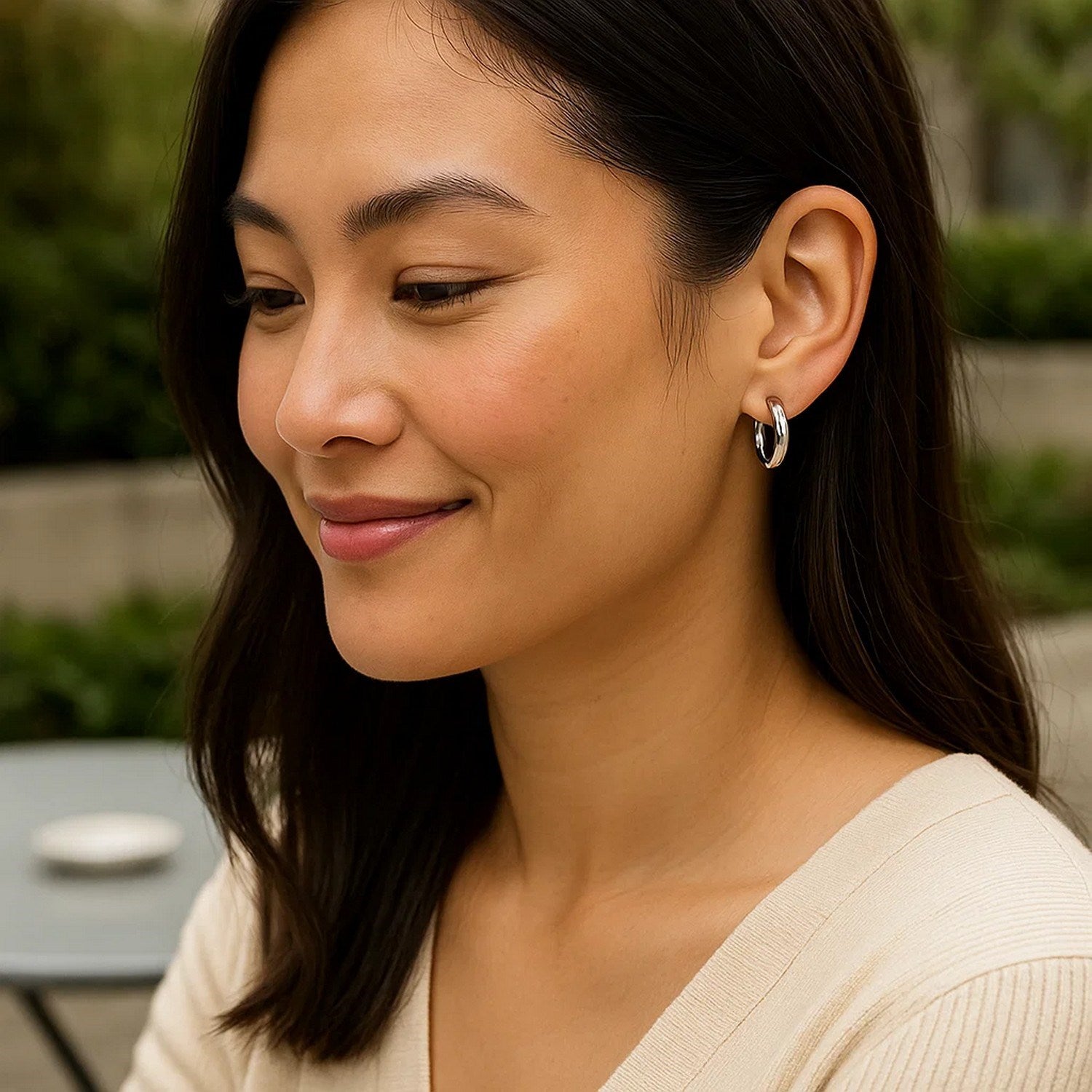 Sterling silver polished hoop earrings with rhodium plating, showcasing a modern design and elegant shine.