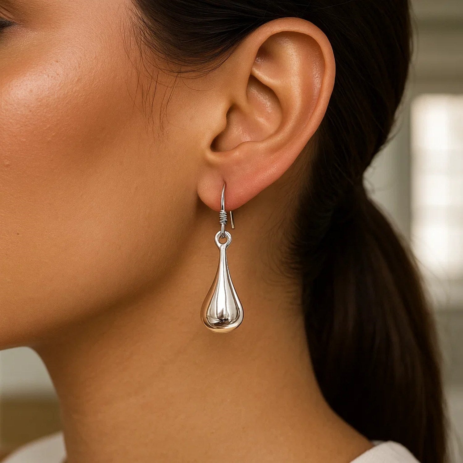 Sterling silver long teardrop puff drop earrings, elegantly designed for a sophisticated look.