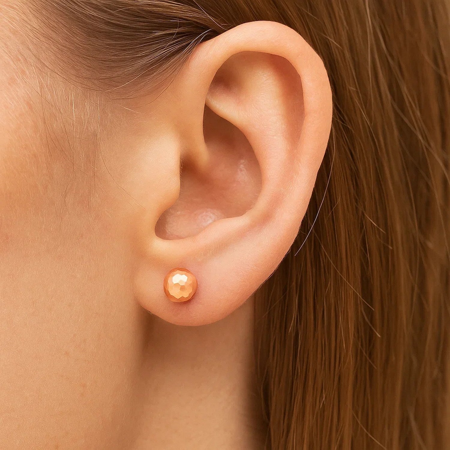 14k rose gold faceted ball stud earrings showcasing a modern design with exquisite craftsmanship and elegant shine.