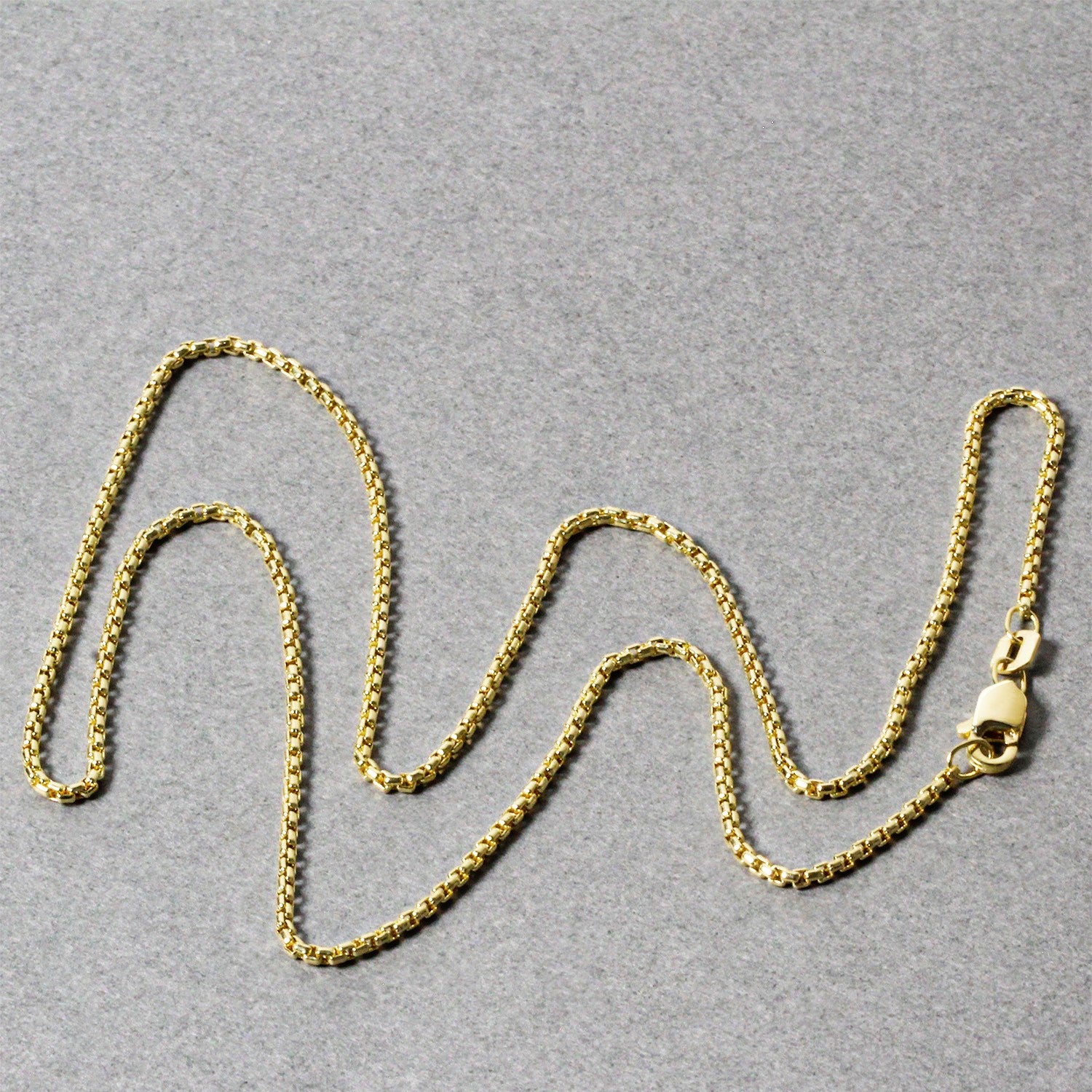 14k yellow gold round box chain, 1.3 mm, classic design with a polished finish, perfect for layering or standalone elegance.
