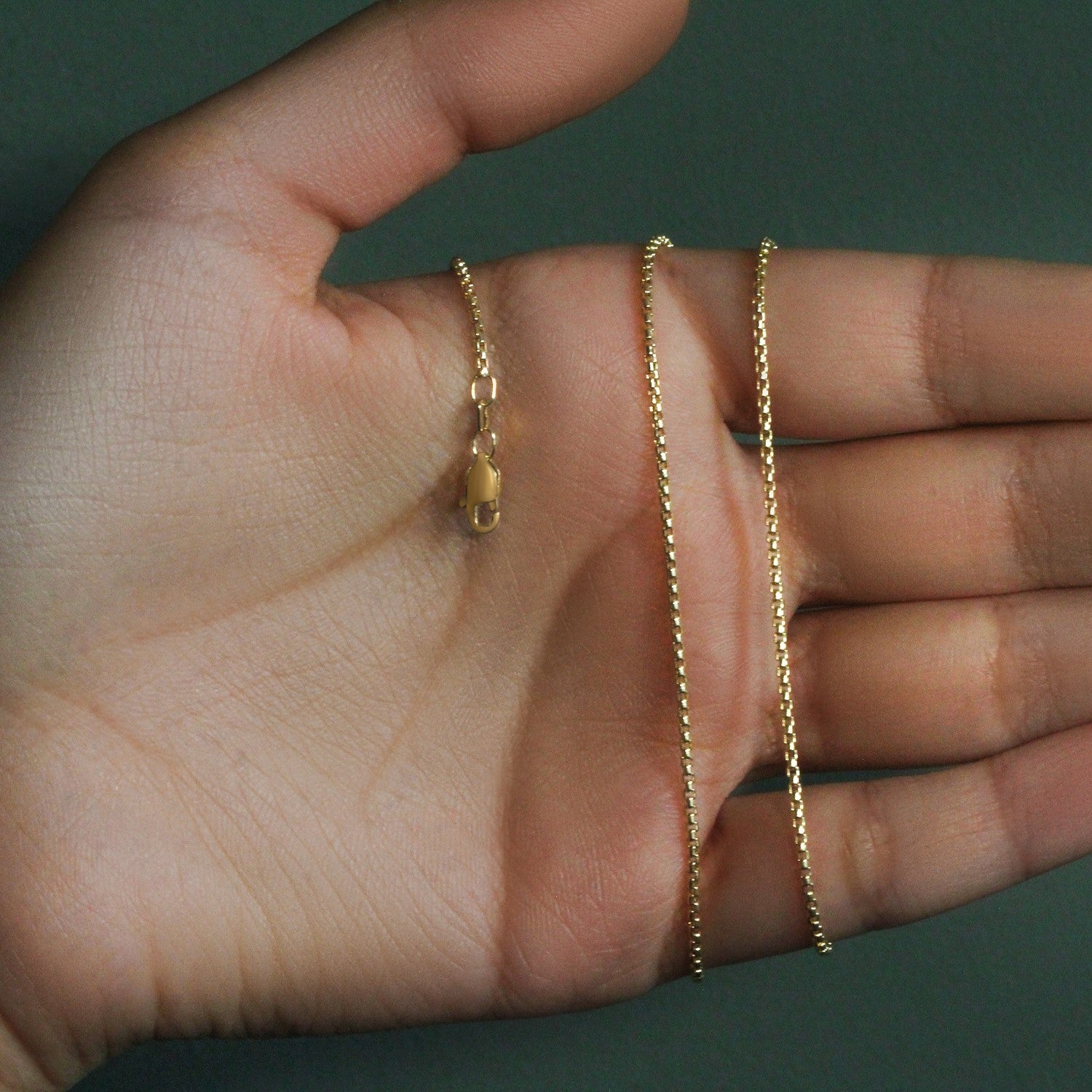 14k yellow gold round box chain, 1.3 mm, showcasing a classic design with a luxurious, polished finish.
