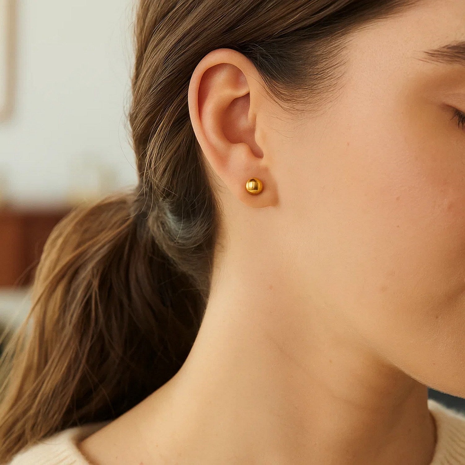 14k yellow gold round stud earrings (6mm) with a modern design, perfect for elegant everyday wear.