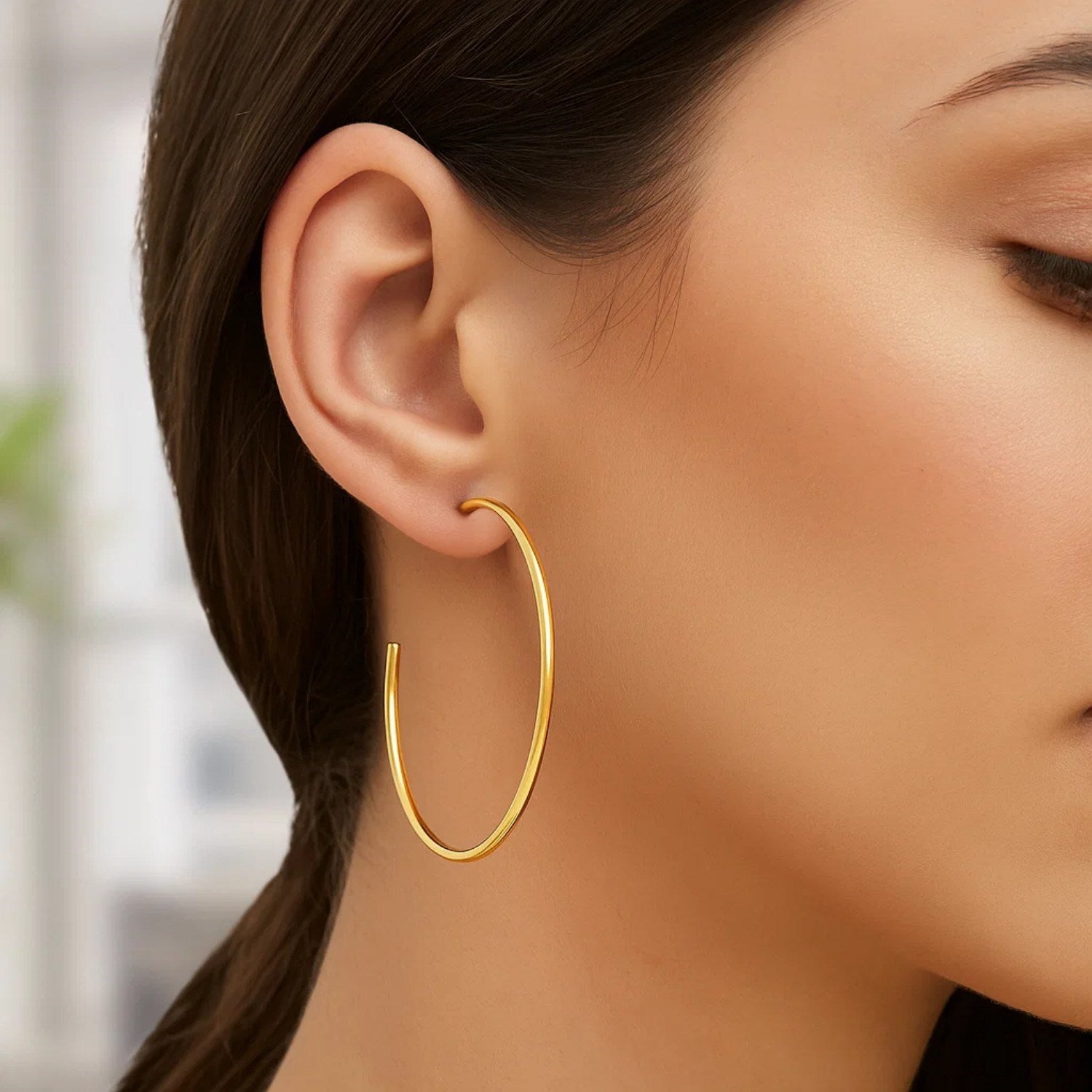 14k yellow gold polished hoop earrings showcasing a classic design, perfect for elegant everyday wear.