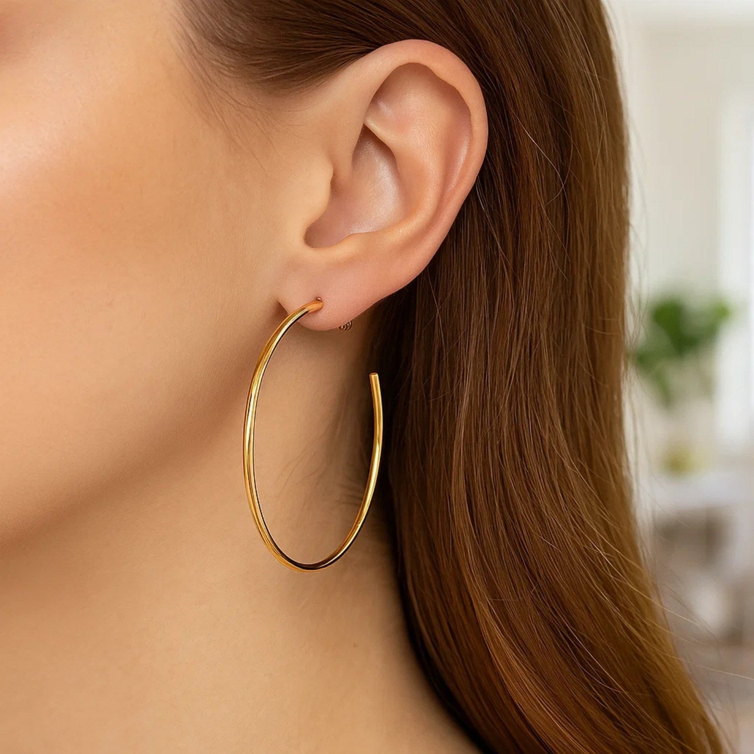 14k yellow gold polished hoop earrings showcasing a classic design, perfect for elegant everyday wear.