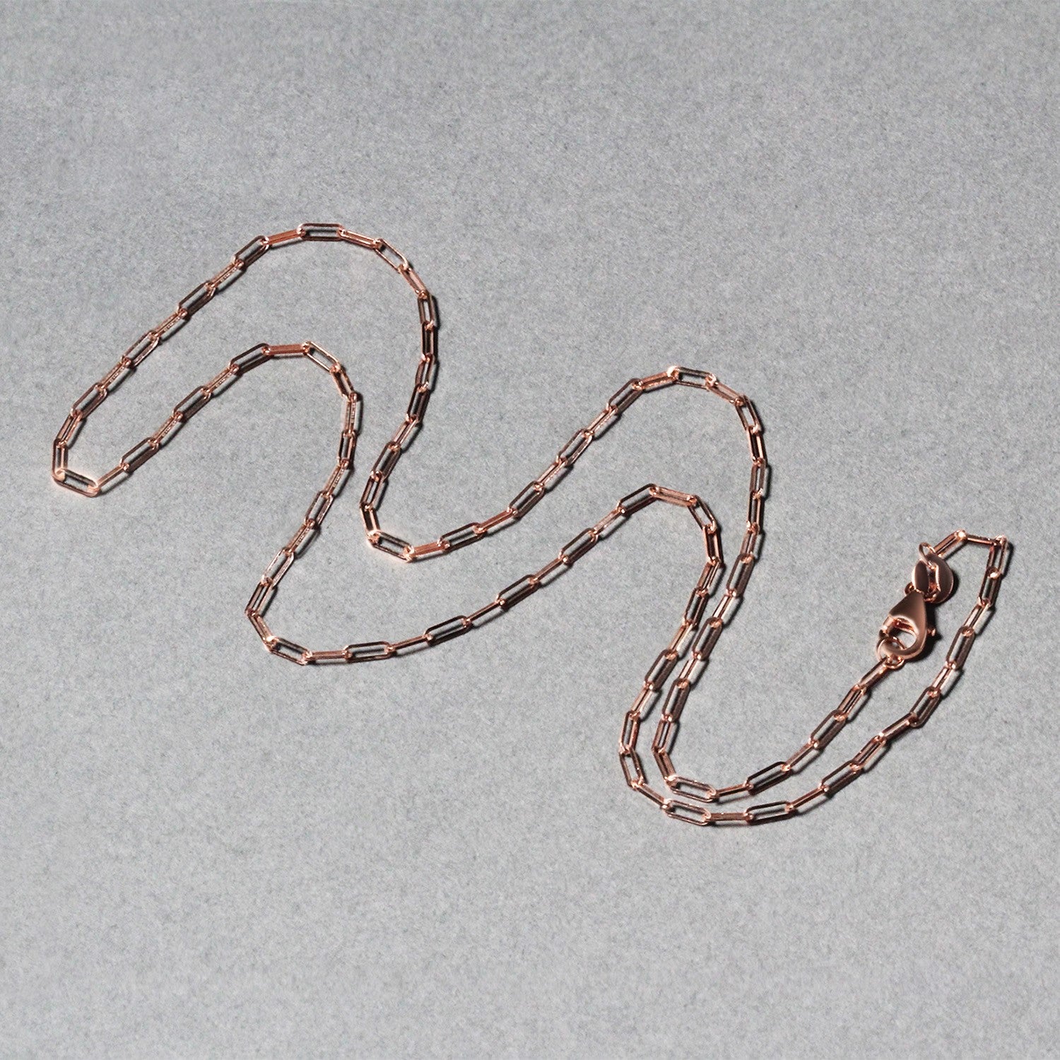 14k rose gold fine paperclip chain with modern links, perfect for layering or as a statement piece.