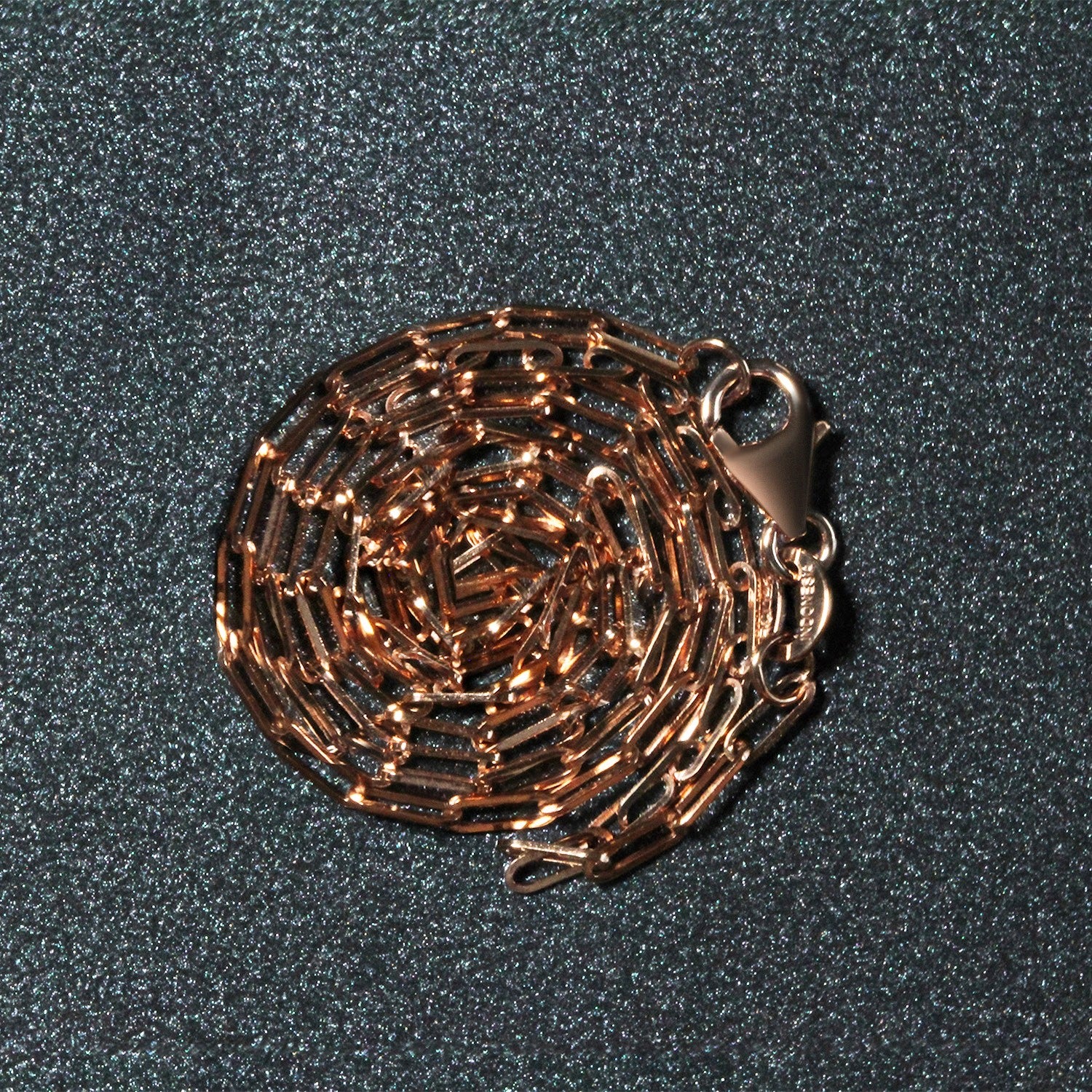 14k rose gold fine paperclip chain with modern links, perfect for layering or wearing solo as a statement piece.