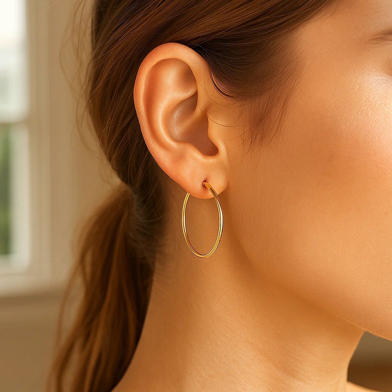 14k yellow gold polished hoop earrings with a sleek modern design, perfect for elegant everyday wear.