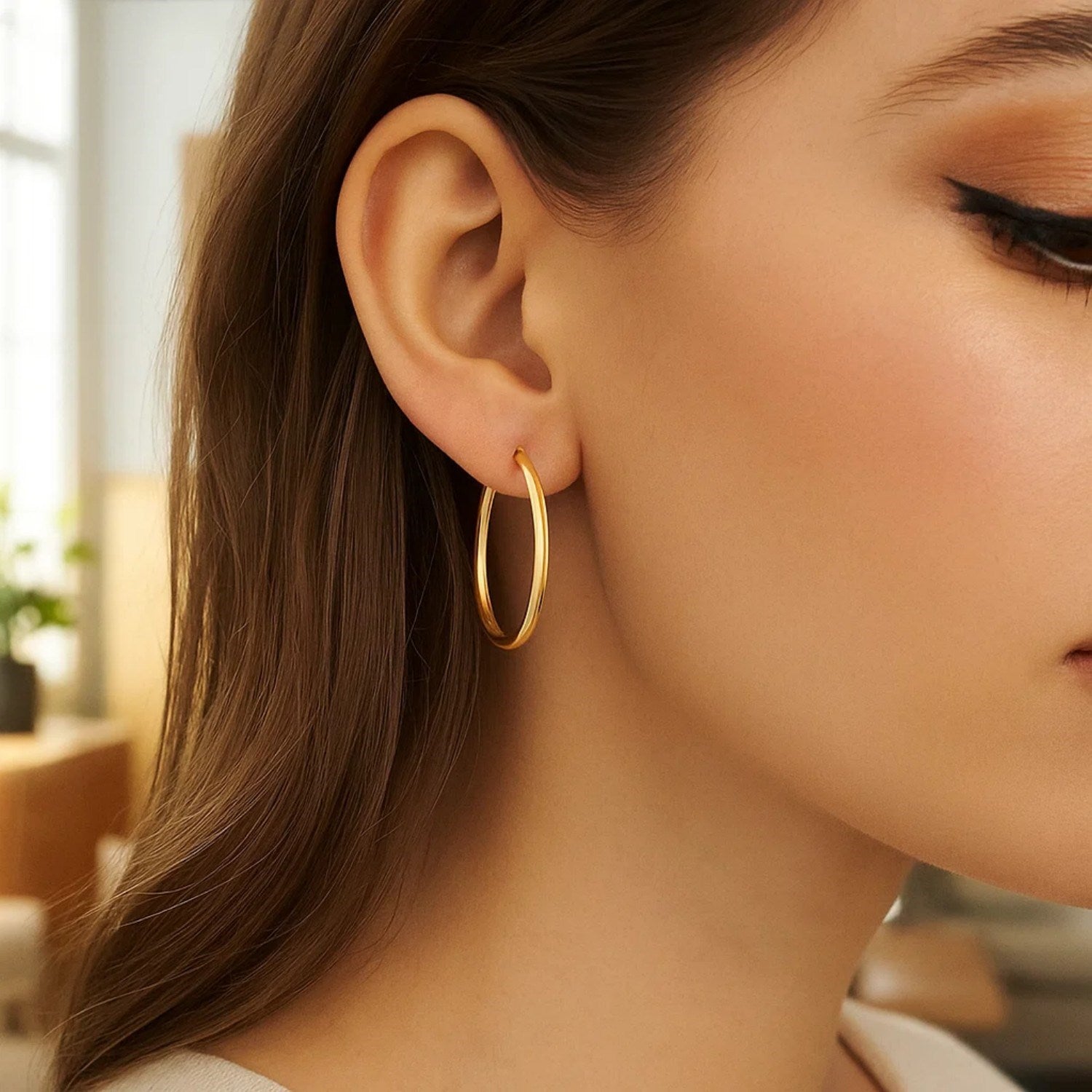 14k yellow gold polished hoop earrings showcasing a classic design, perfect for elegant everyday wear.