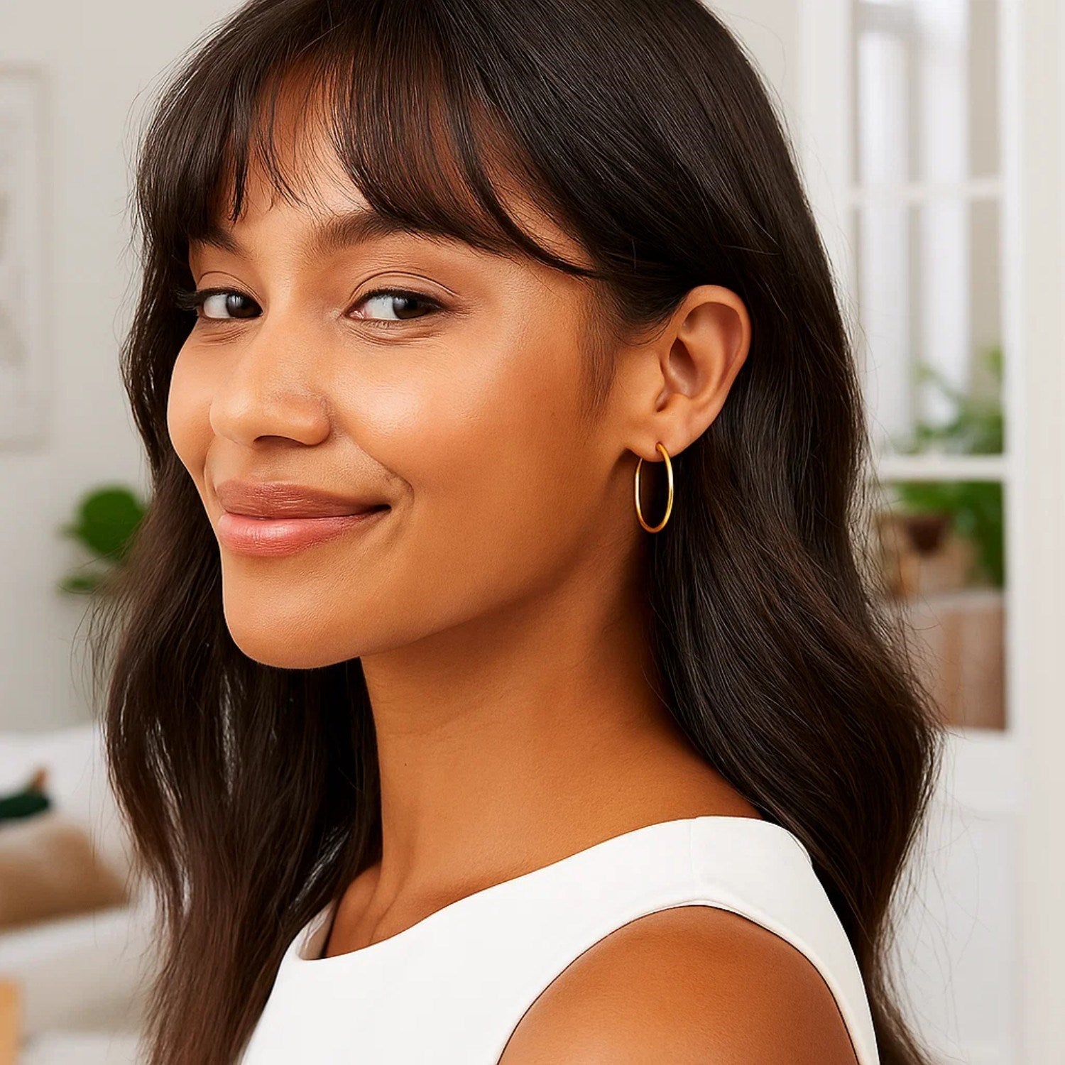 14k yellow gold polished hoop earrings showcasing a classic design, perfect for elegant everyday wear.