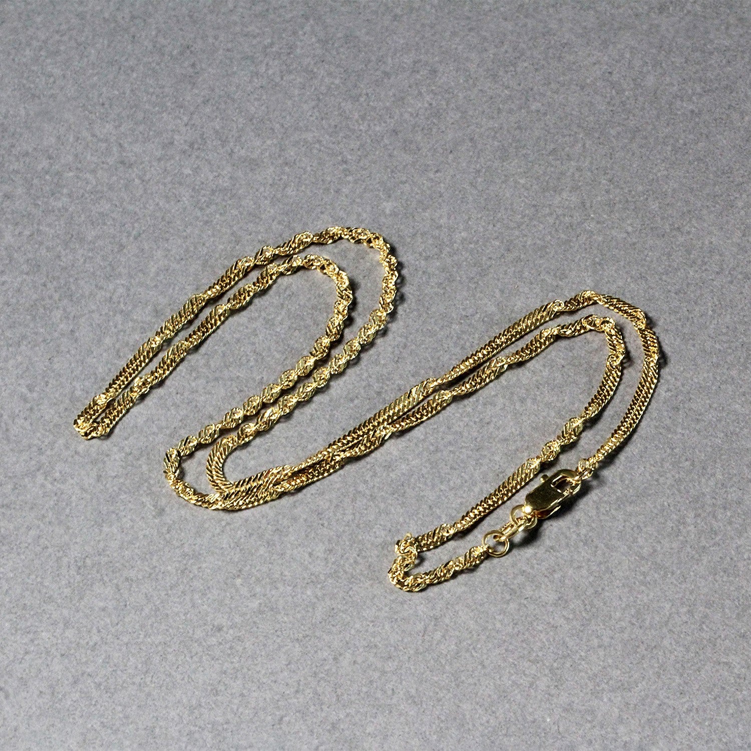 Elegant 14k yellow gold Singapore chain, 1.80 mm, showcasing a refined design perfect for layering or standalone wear.