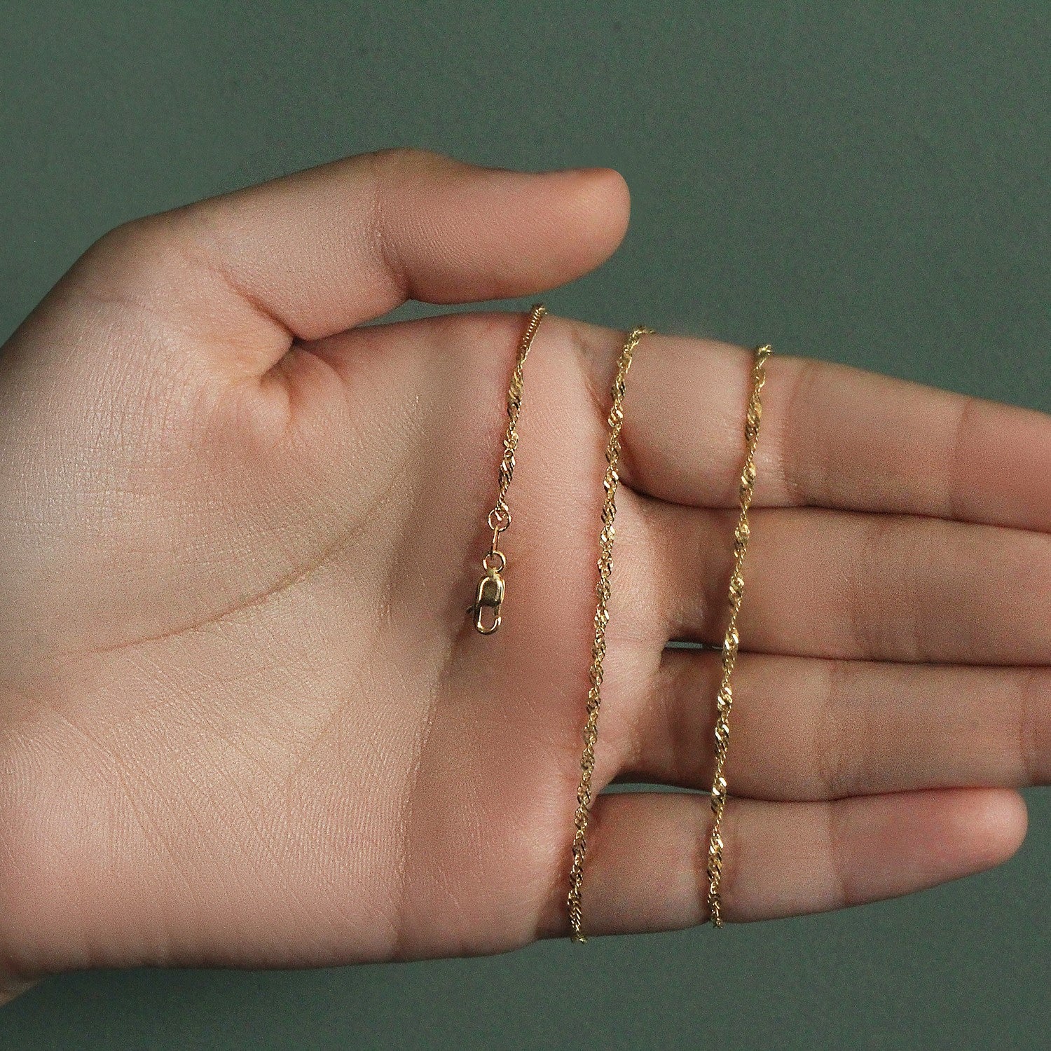 Elegant 14k yellow gold Singapore chain, 1.80 mm, showcasing a refined and luxurious design for sophisticated style.