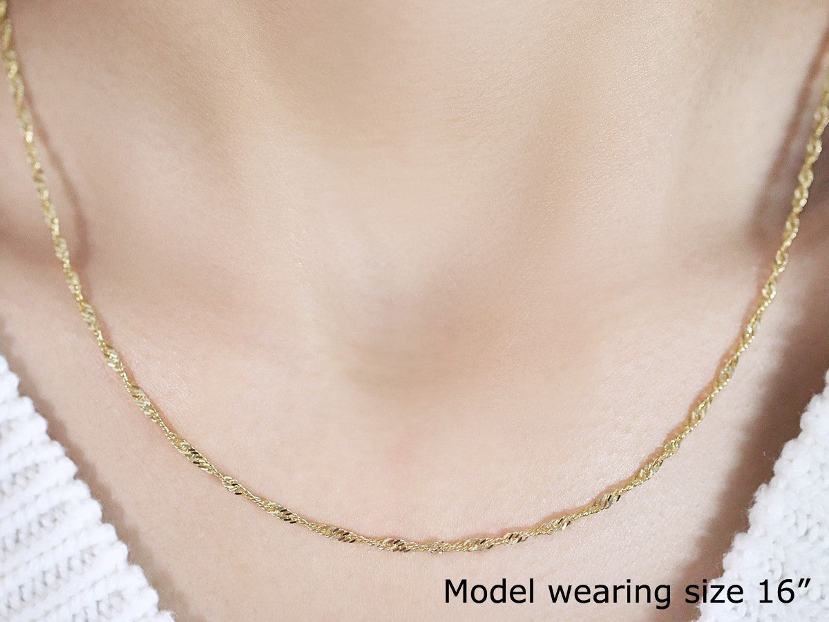 Elegant 14k yellow gold Singapore chain, 1.80 mm, showcasing a refined design perfect for layering or standalone wear.