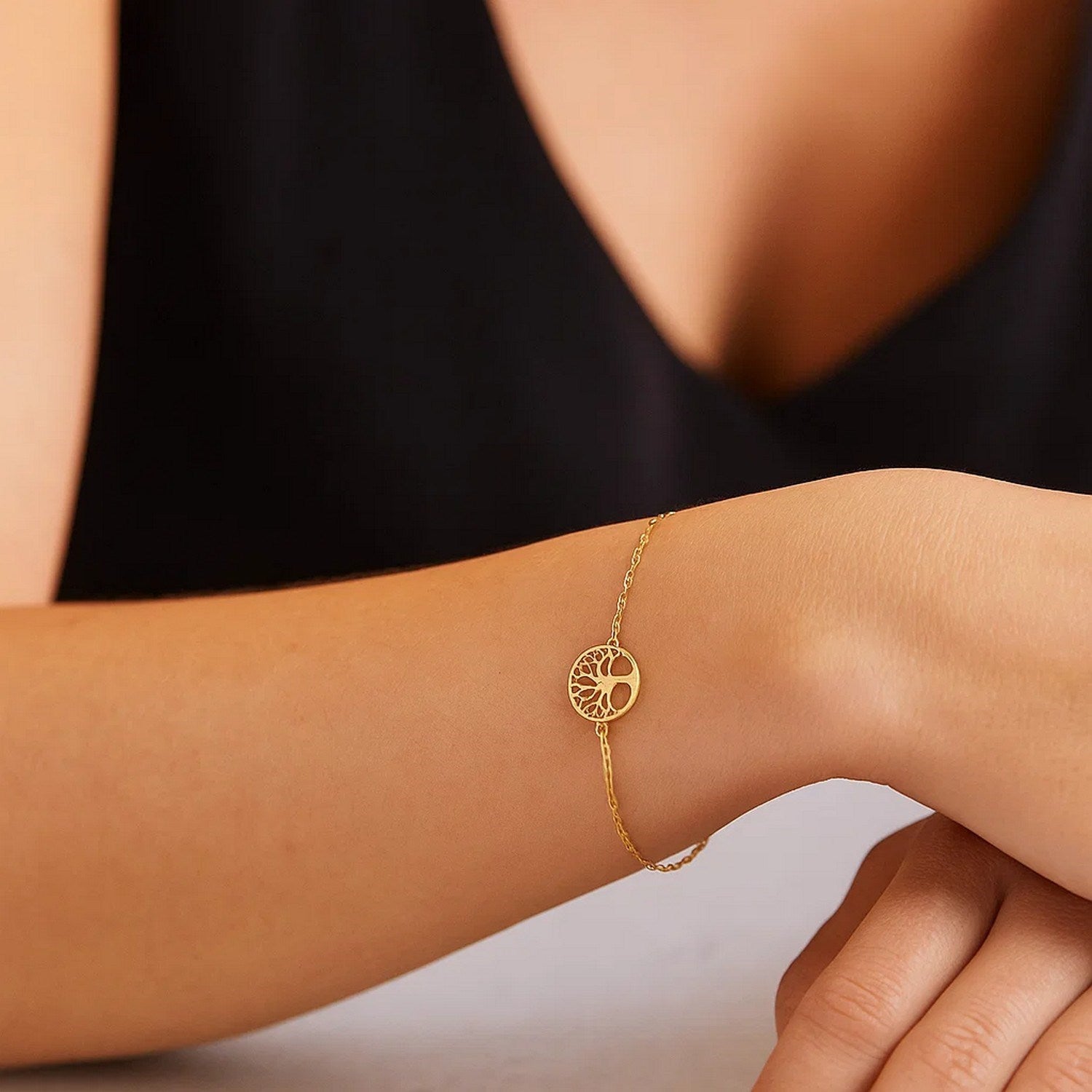Elegant 14k yellow gold Tree of Life bracelet featuring a delicate chain design, perfect for luxury jewelry enthusiasts.