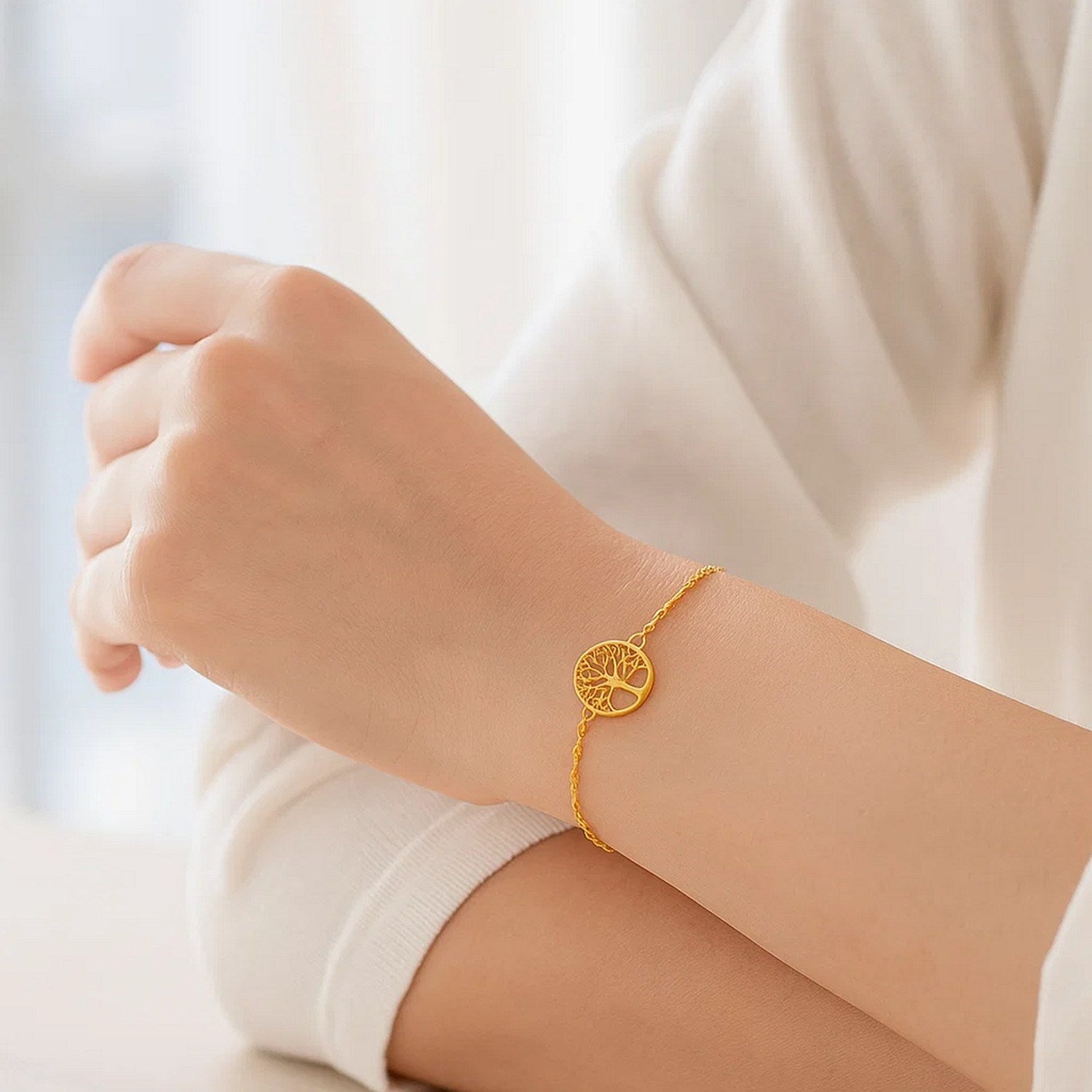Elegant 14K yellow gold Tree of Life bracelet with a delicate chain design, showcasing timeless luxury and craftsmanship.
