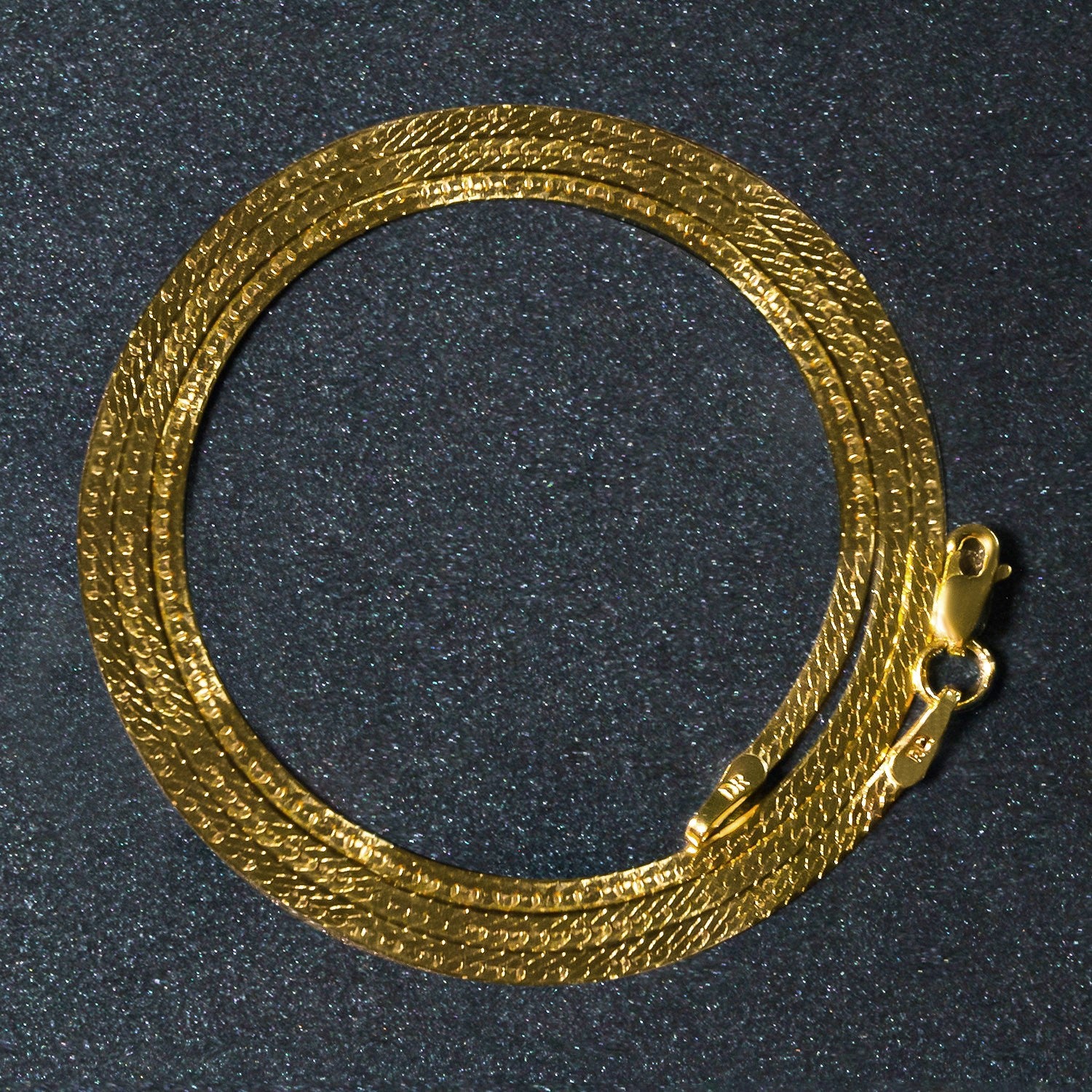 Elegant 14k yellow gold super flex herringbone chain, 1.50 mm, showcasing a sleek, sophisticated design.