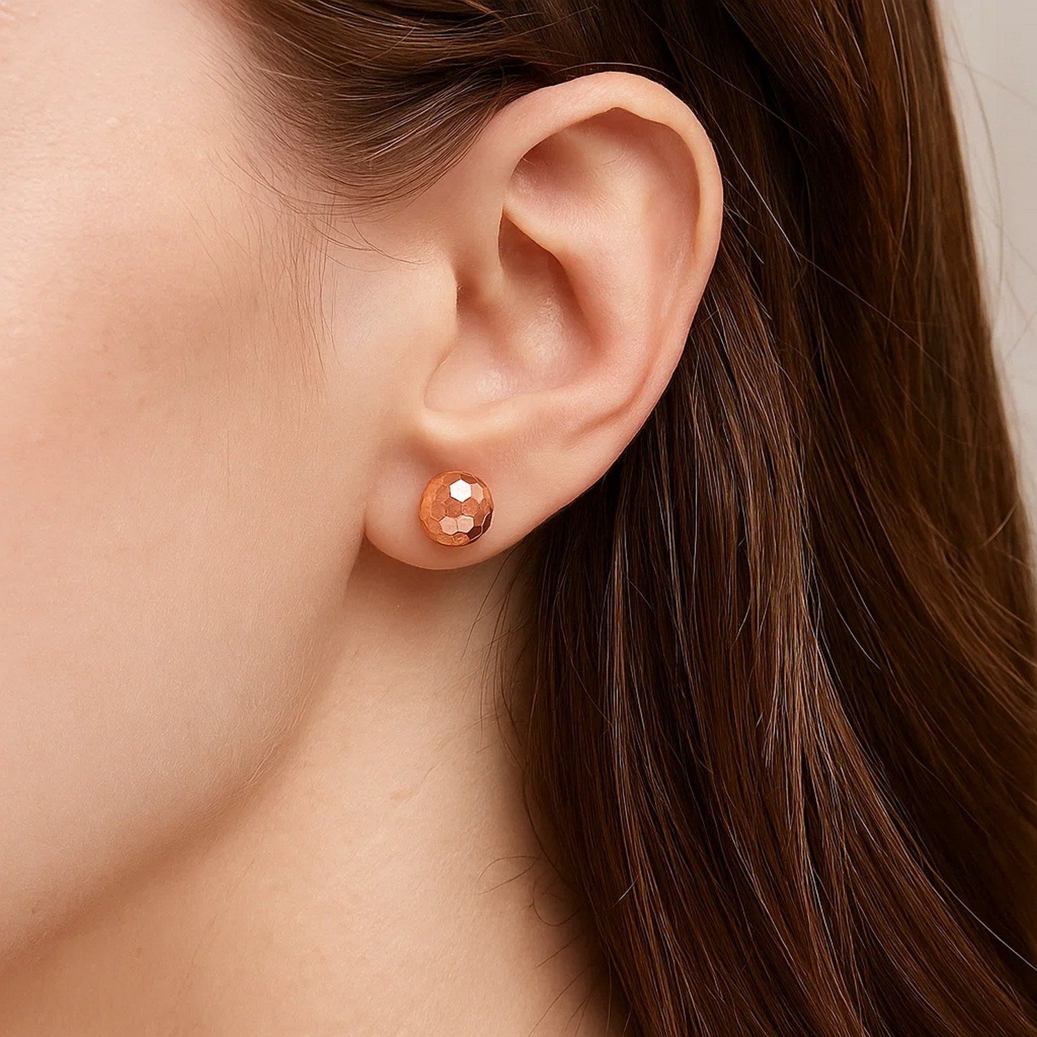 14k rose gold faceted stud earrings showcasing a modern design with elegant simplicity and refined craftsmanship.
