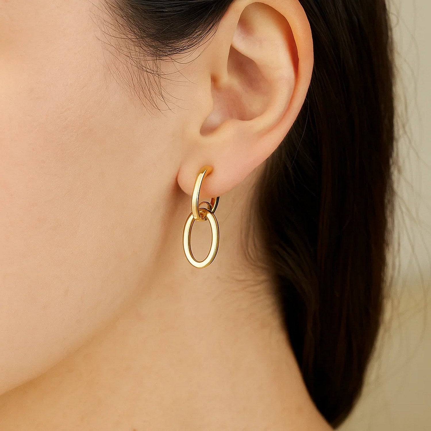 14k yellow gold interlocking drop hoop earrings with a modern design, perfect for elegant occasions.