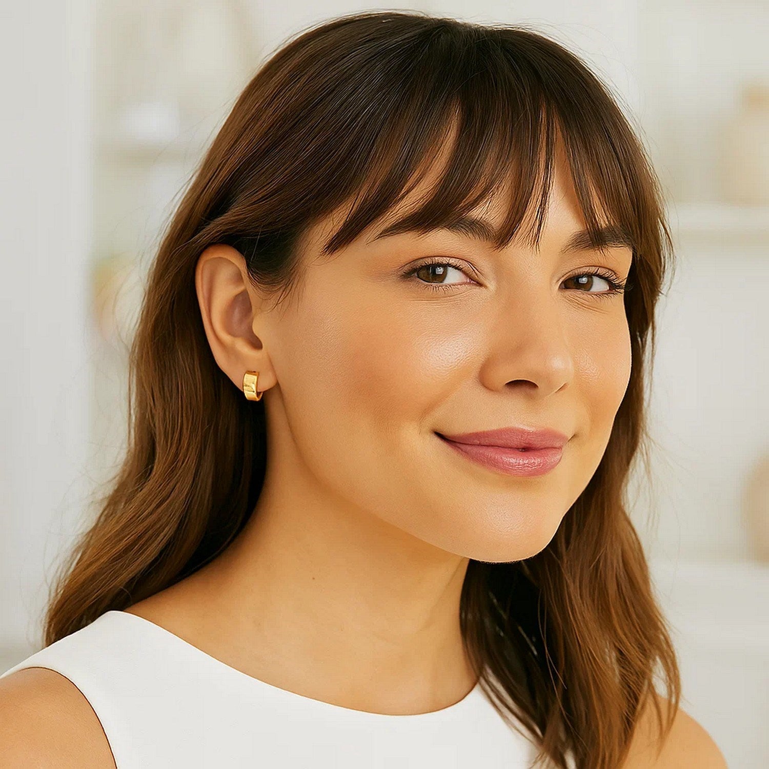 Contemporary 14k yellow gold hoop earrings with a sleek, snuggable design for effortless elegance.